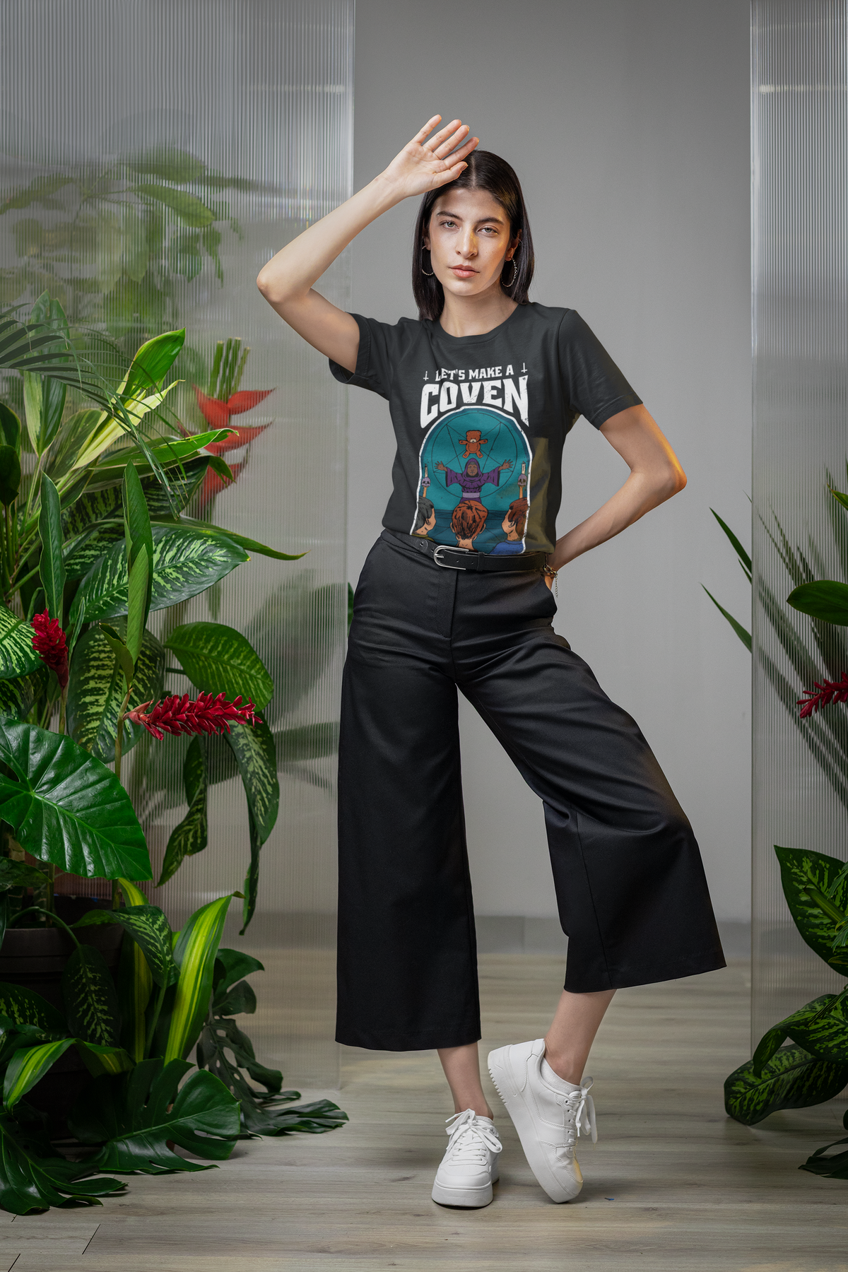 'Let's Make A Coven' t-shirt in black, woman posing with plants, spooky Halloween gift shirt