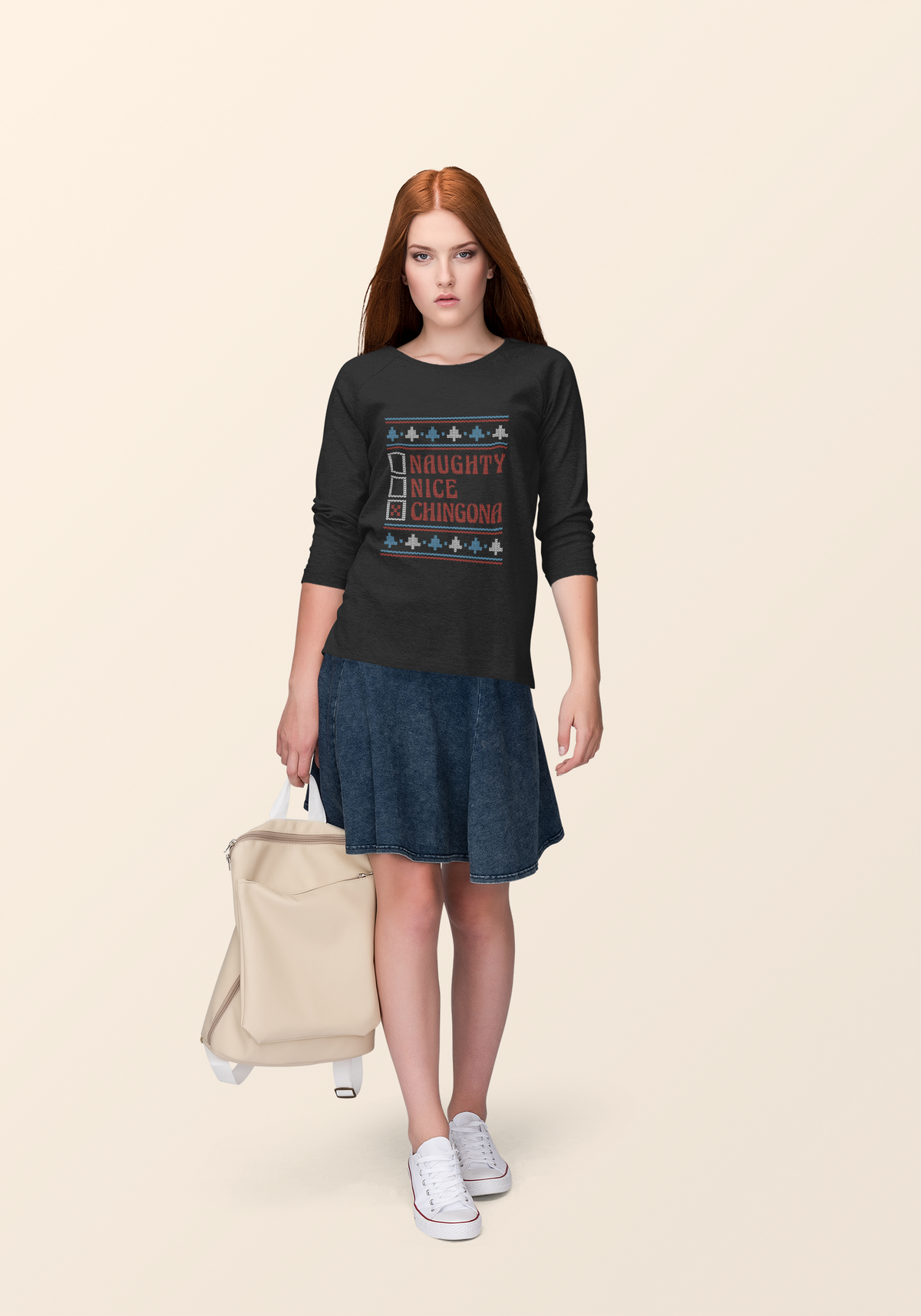 'Naughty Nice Chingona' ugly sweater sweatshirt in black, woman wearing it outdoors, holiday gift