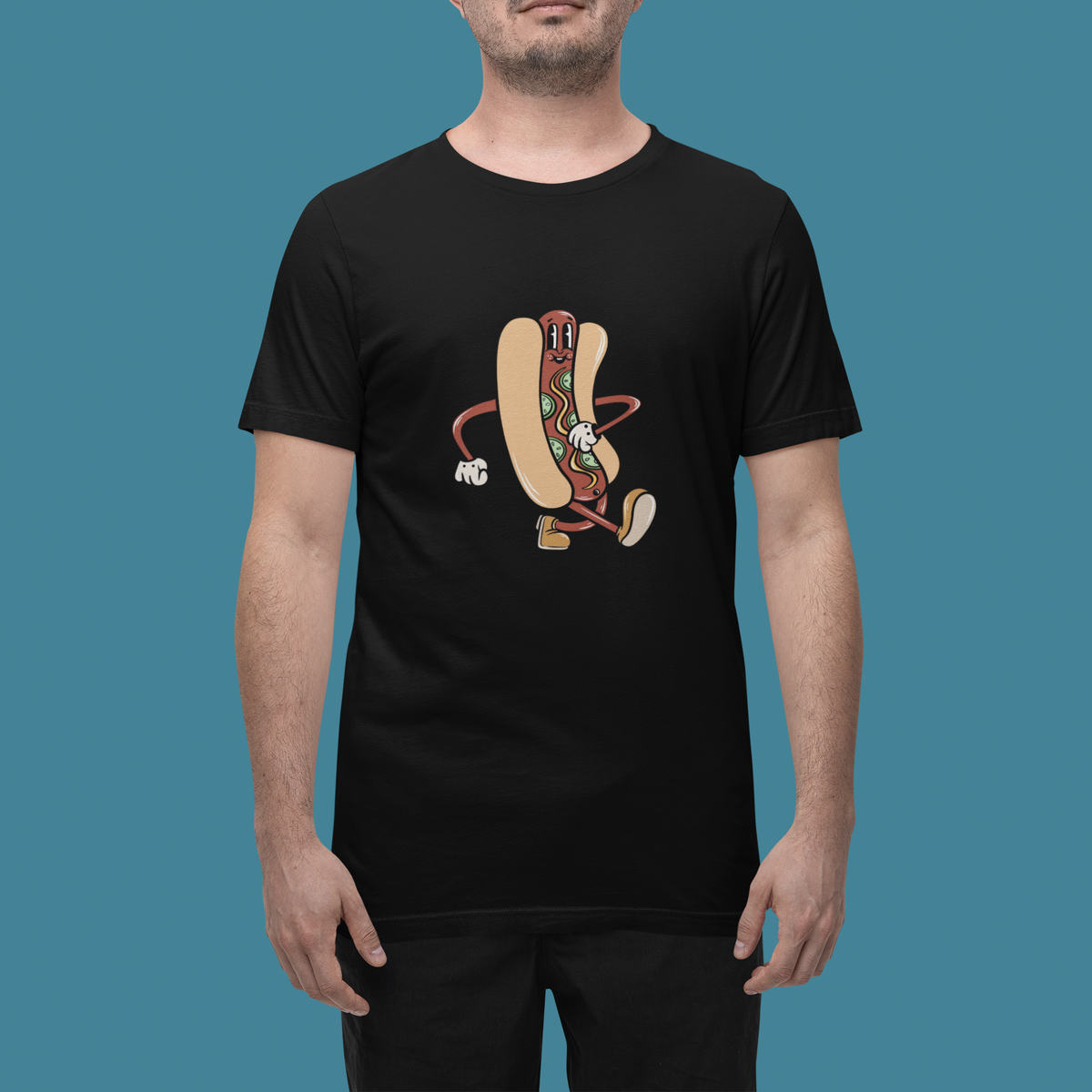 'Hotdog Cartoon' t-shirt in black, man wearing it in a studio, T-Shirt mockup, Geekpsters