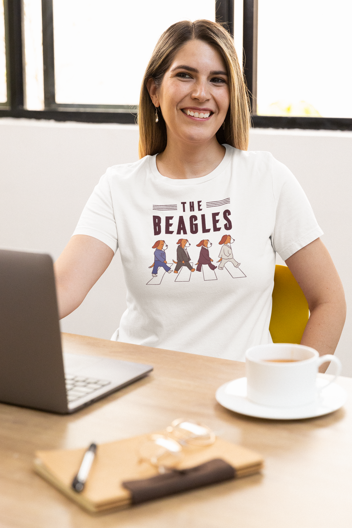 'The Beagles' t-shirt in white, woman model wearing it at a home office desk, funny gift for dog lovers