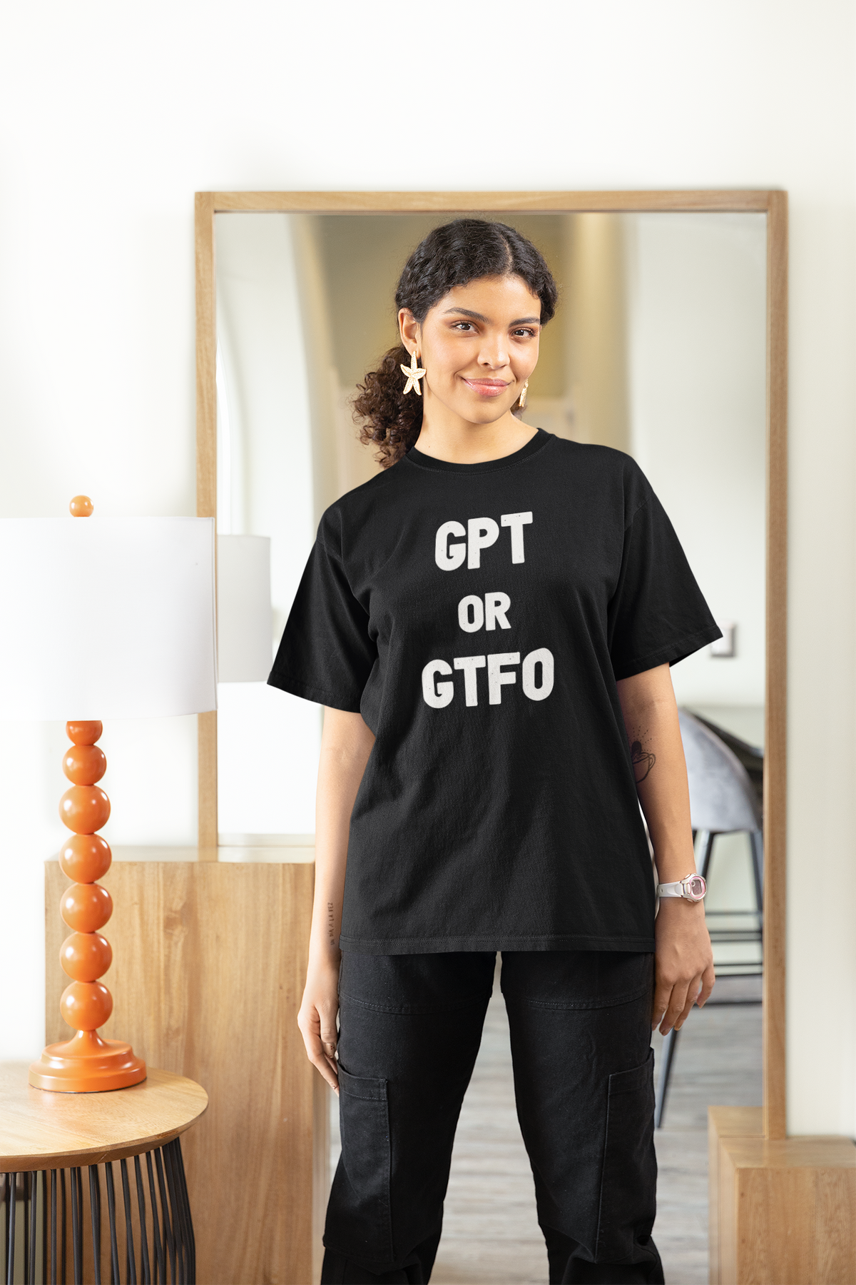 'GPT or GTFO' women's tee in black, woman wearing it at home in mirror, funny gift for tech lovers