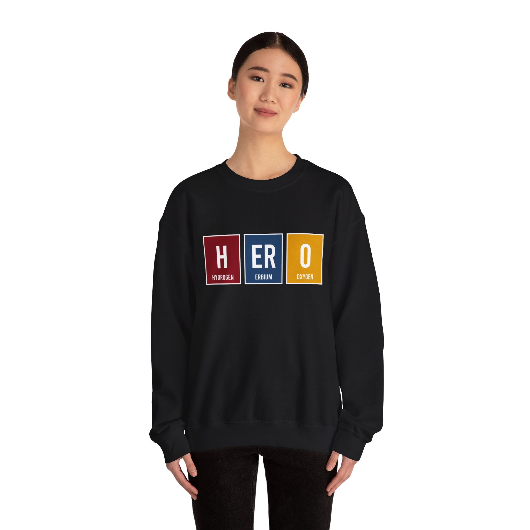 Person wearing a HERO - Sweatshirt with a periodic table style "HERO" on the front, showcasing comfort and style perfect for making winters warmer.