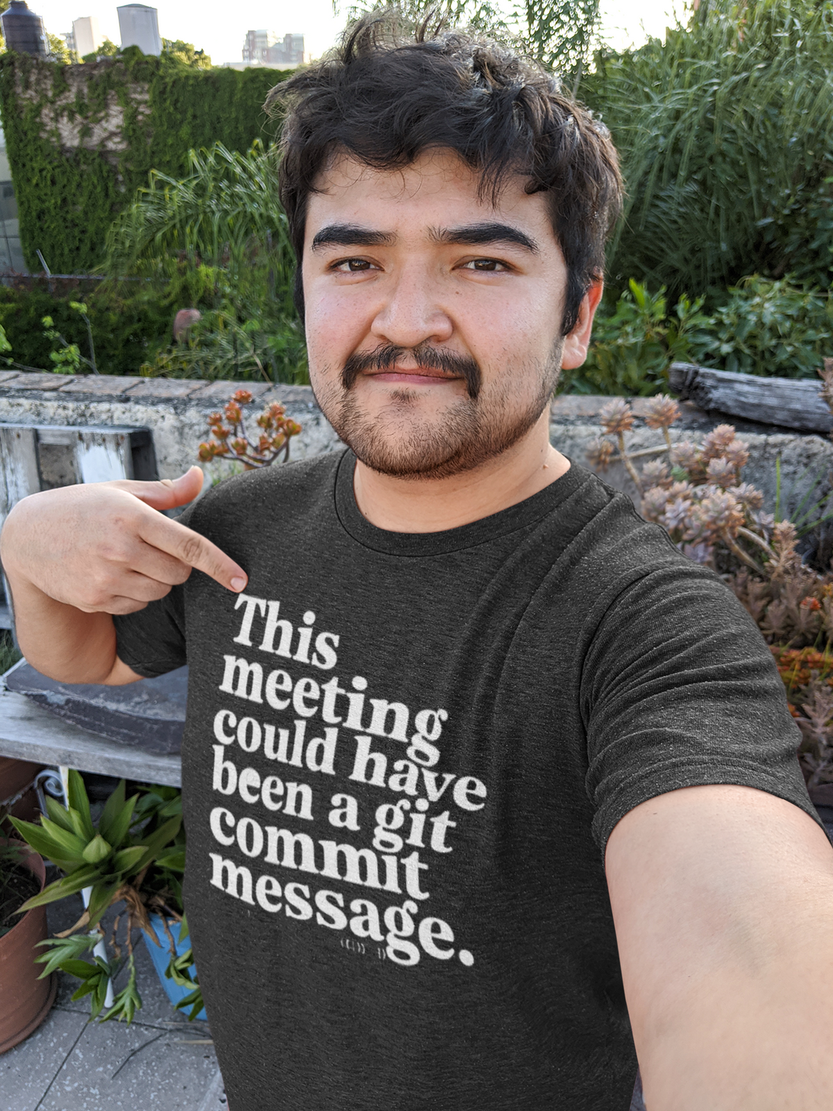 ‘This Meeting Could Have Been a Git Commit Message’ grey tee, man wearing it outdoors, funny developer gift