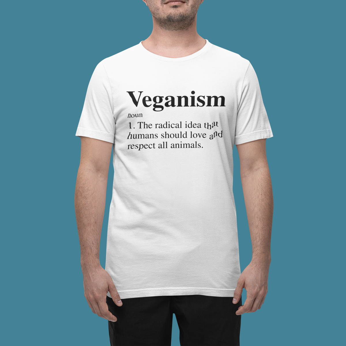 'Veganism' definition T-shirt in white, man wearing it, front view, funny vegan lifestyle gift tee