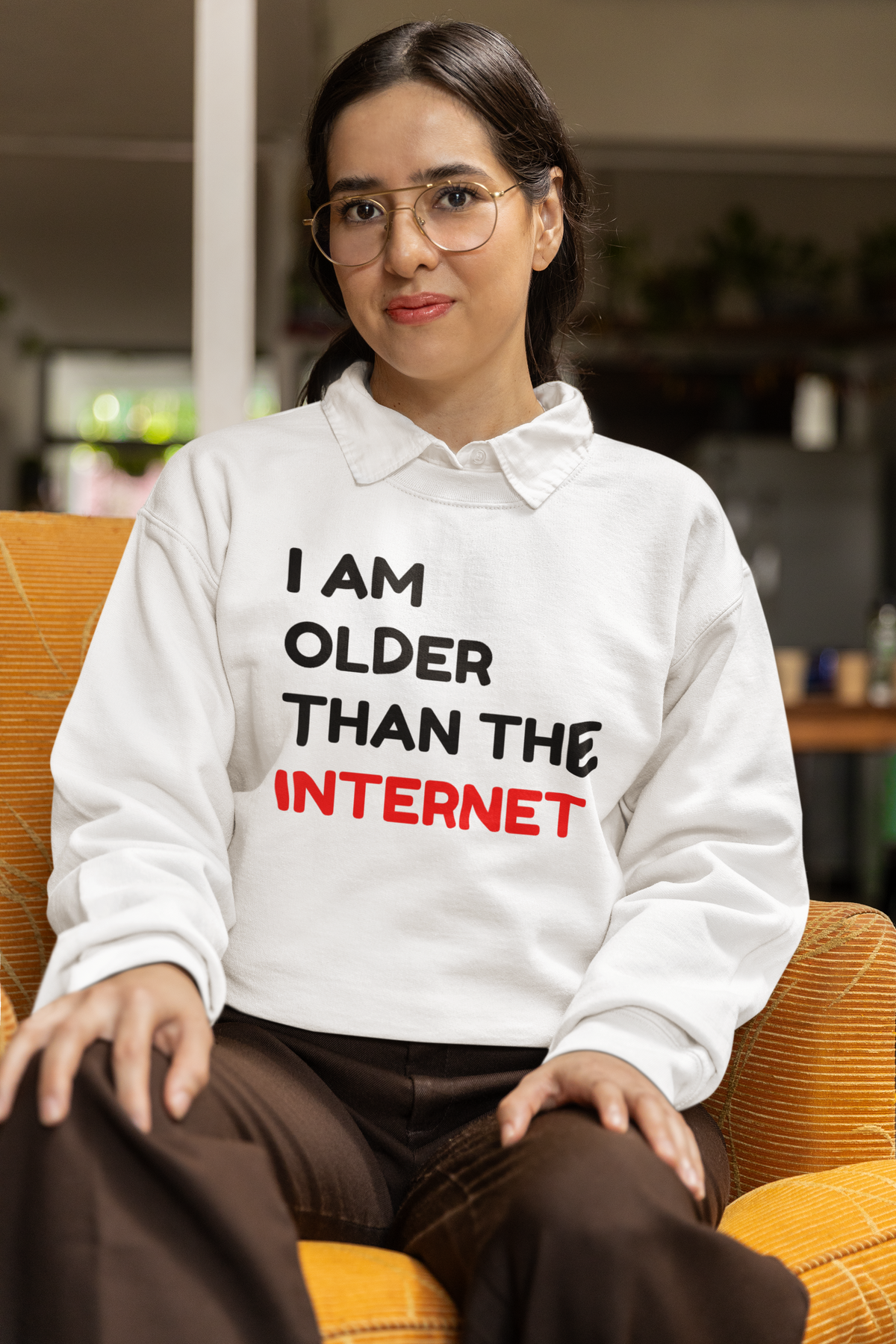 'I Am Older Than the Internet' sweatshirt in white, man wearing it against a tan backdrop, funny nostalgic gift