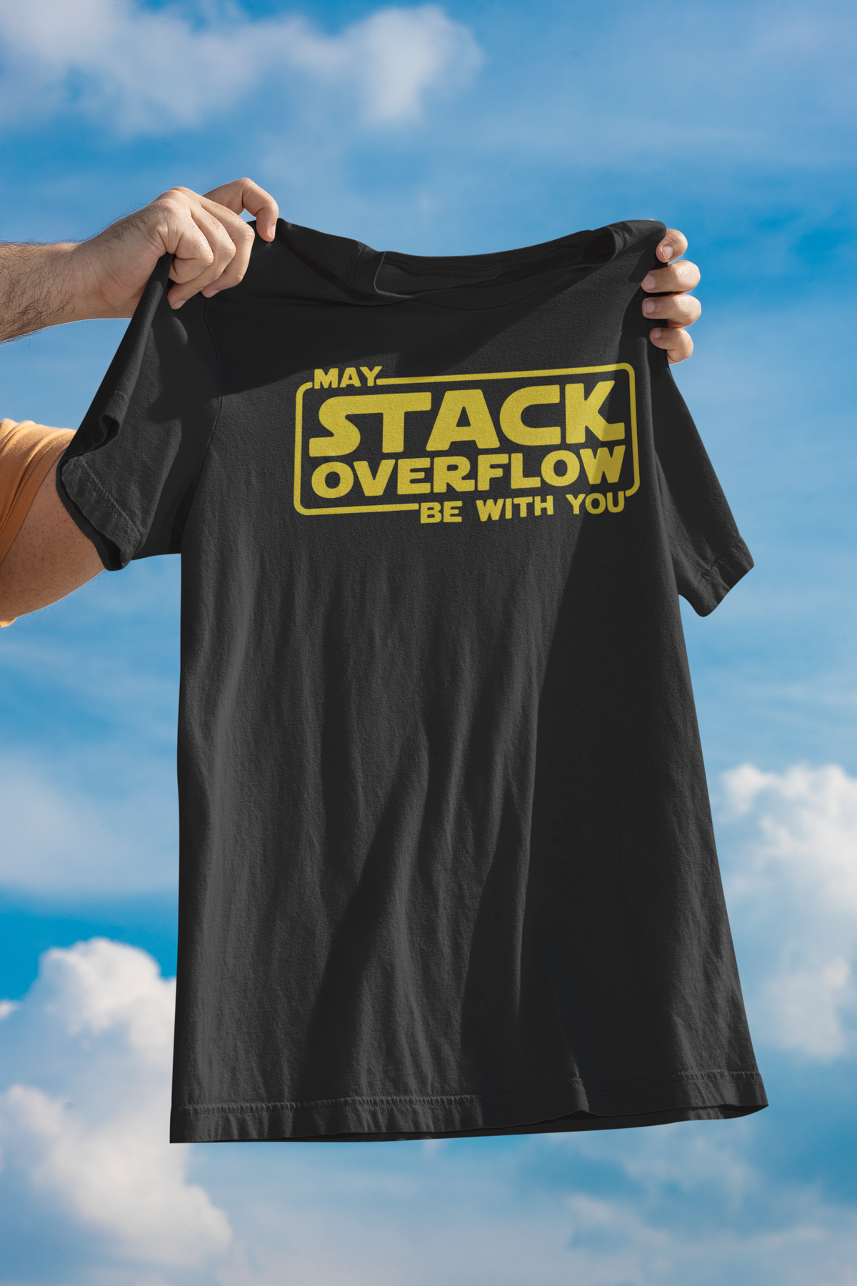 'May Stack Overflow Be With You' oversized t-shirt in black, man holding it up outdoors, funny developer gift