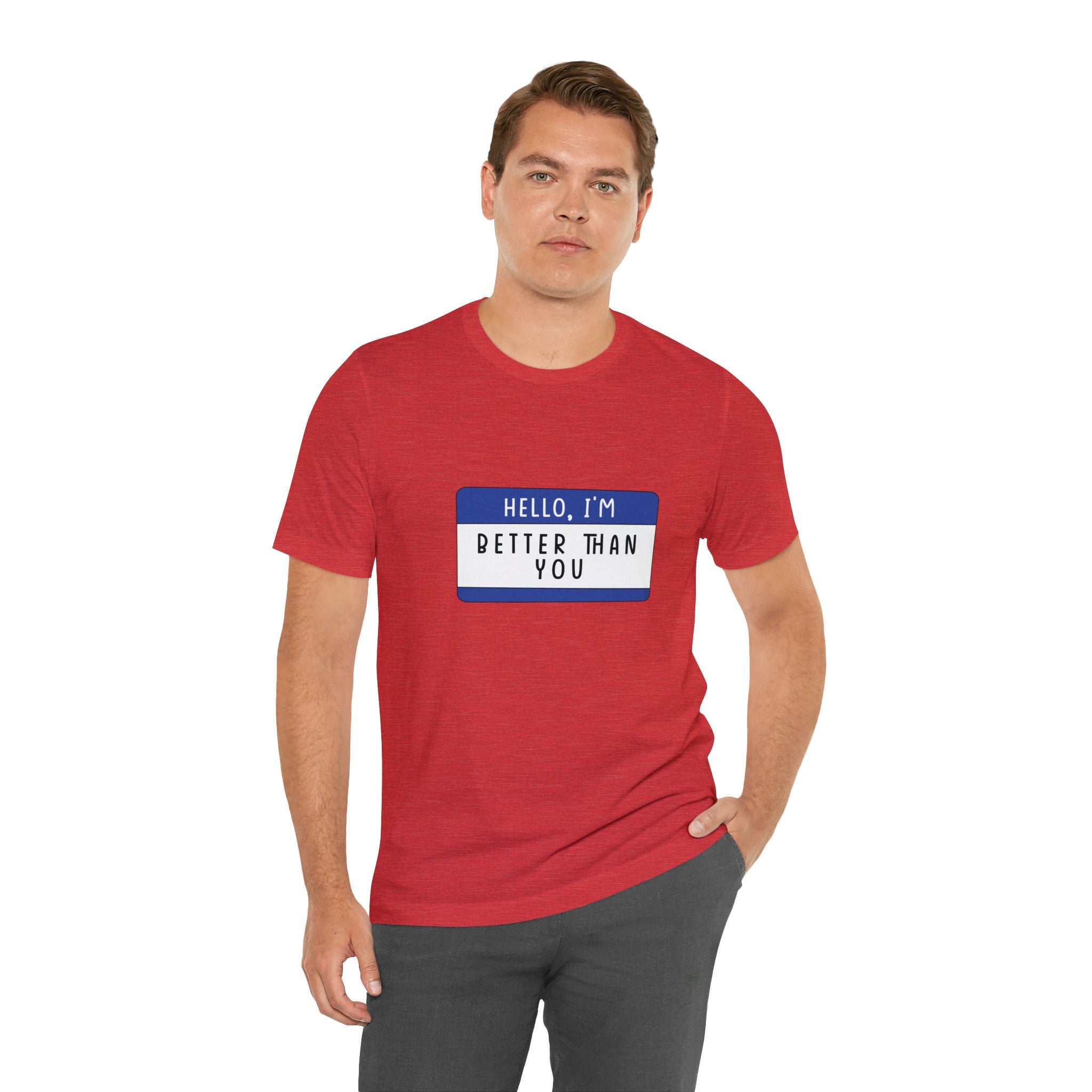 Sentence with Product Name: Man in a Hello, I'm Better Than You T-Shirt with geeky charm, sporting a blue name tag graphic that reads "hello, i'm better than you," posing with one hand on his hip.