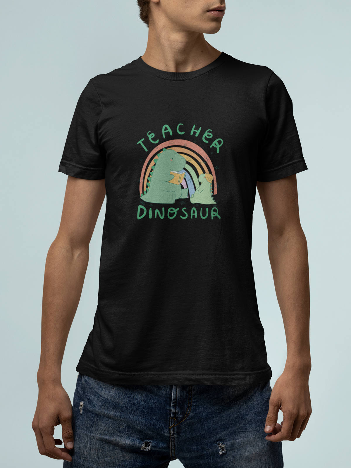 'Teacher Dinosaur' t-shirt in black, man against a light backdrop