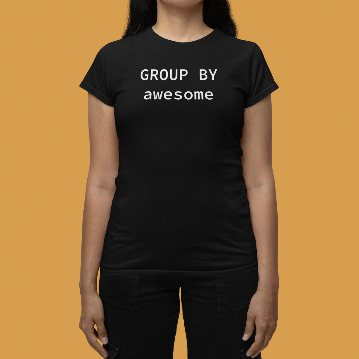 'GROUP BY Awesome' women's tee in black, woman wearing it warm toned studio, funny gift for coders