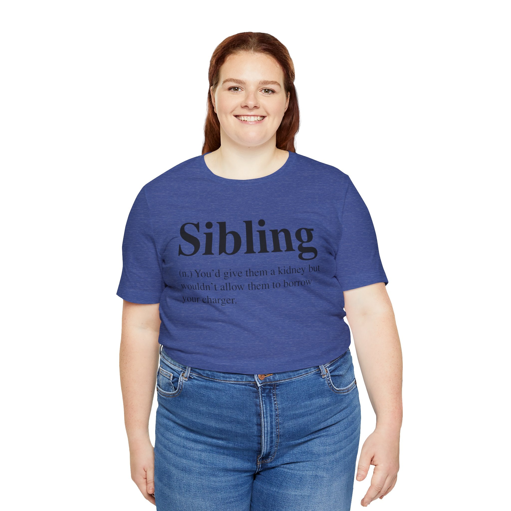 Woman in a soft cotton blue Sibling T-Shirt with the word "sibling" and a humorous definition printed on it, smiling at the camera.