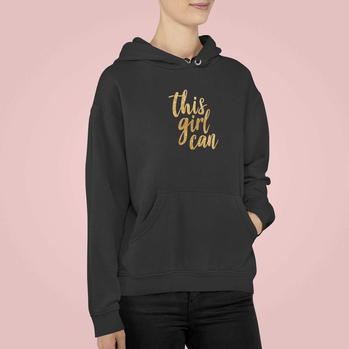 This Girl Can Hoodie in black, woman wearing it against a pink backdrop, motivational gift