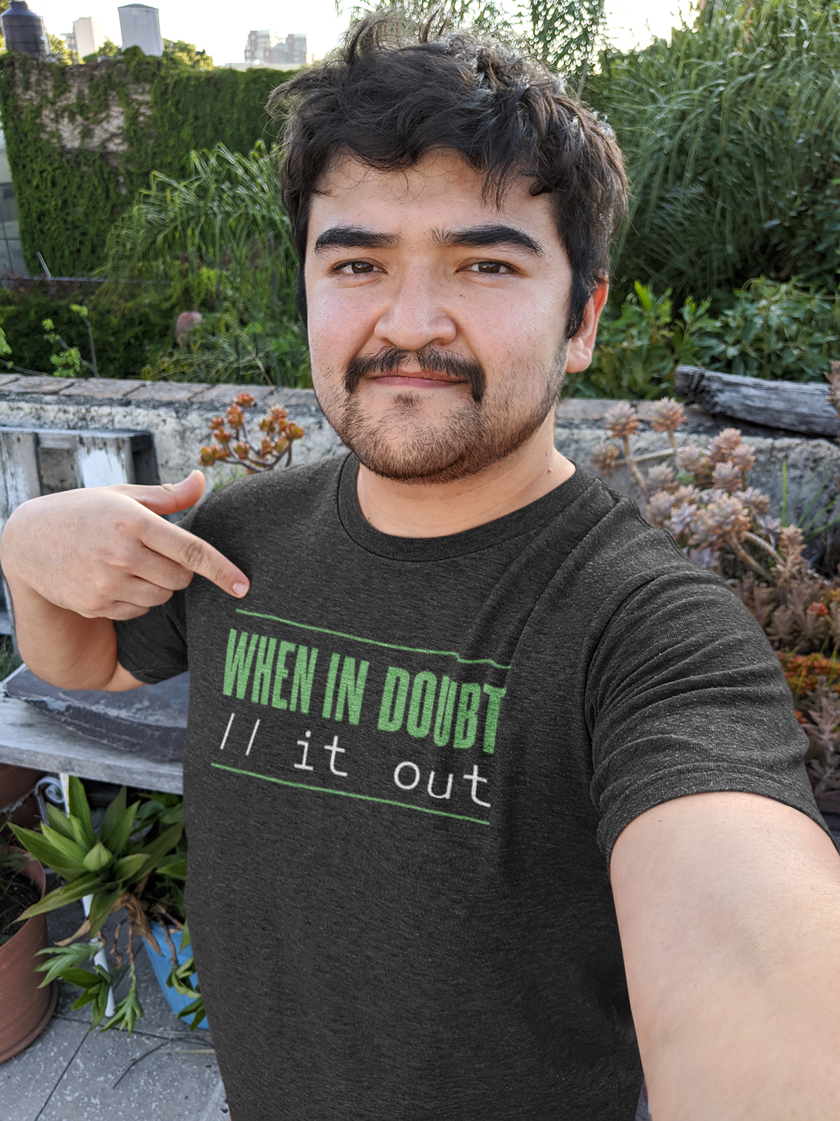 'When In Doubt, Print It Out' t-shirt in black, man model wearing it outdoors in a garden