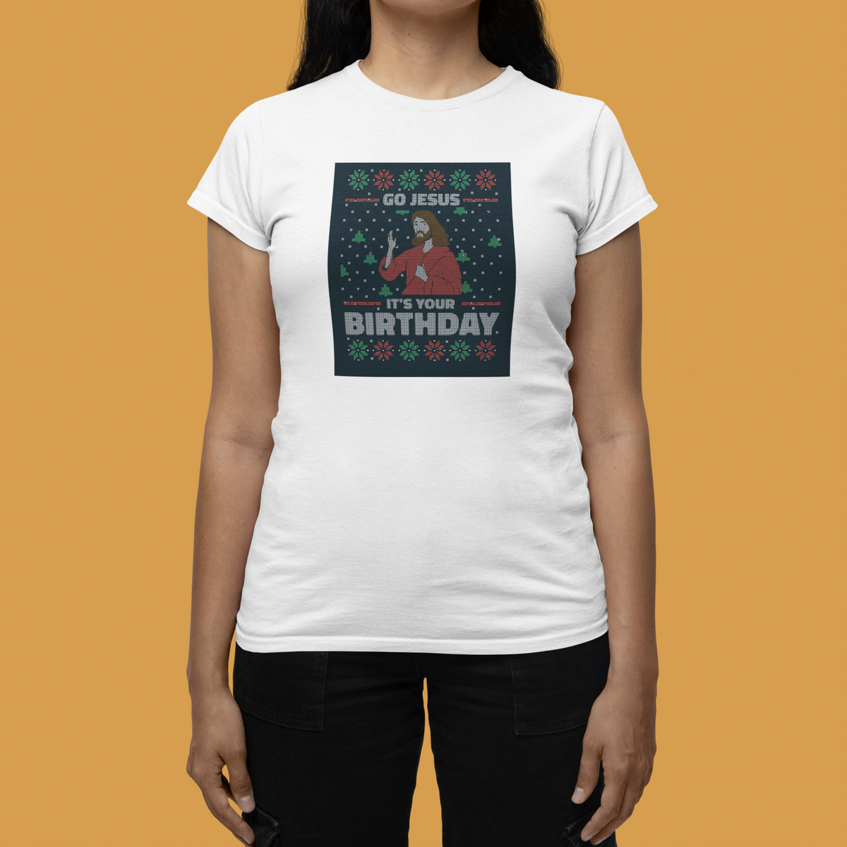 'Go Jesus It's Your Birthday' Women's T-Shirt in white, woman modeling it against an orange backdrop