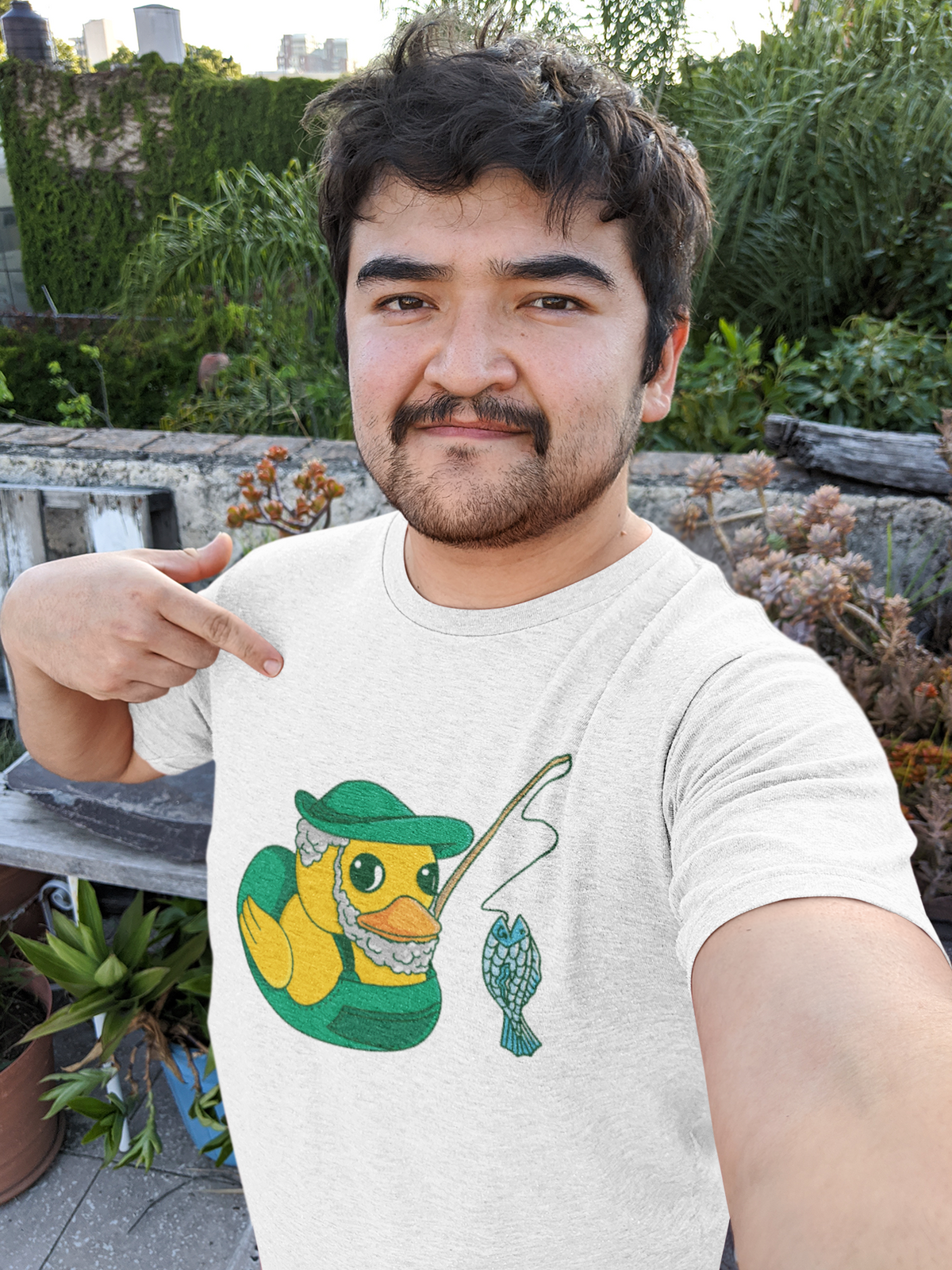 Fisherman duck t-shirt in white, man model wearing it outdoors, funny gift for fishing lovers