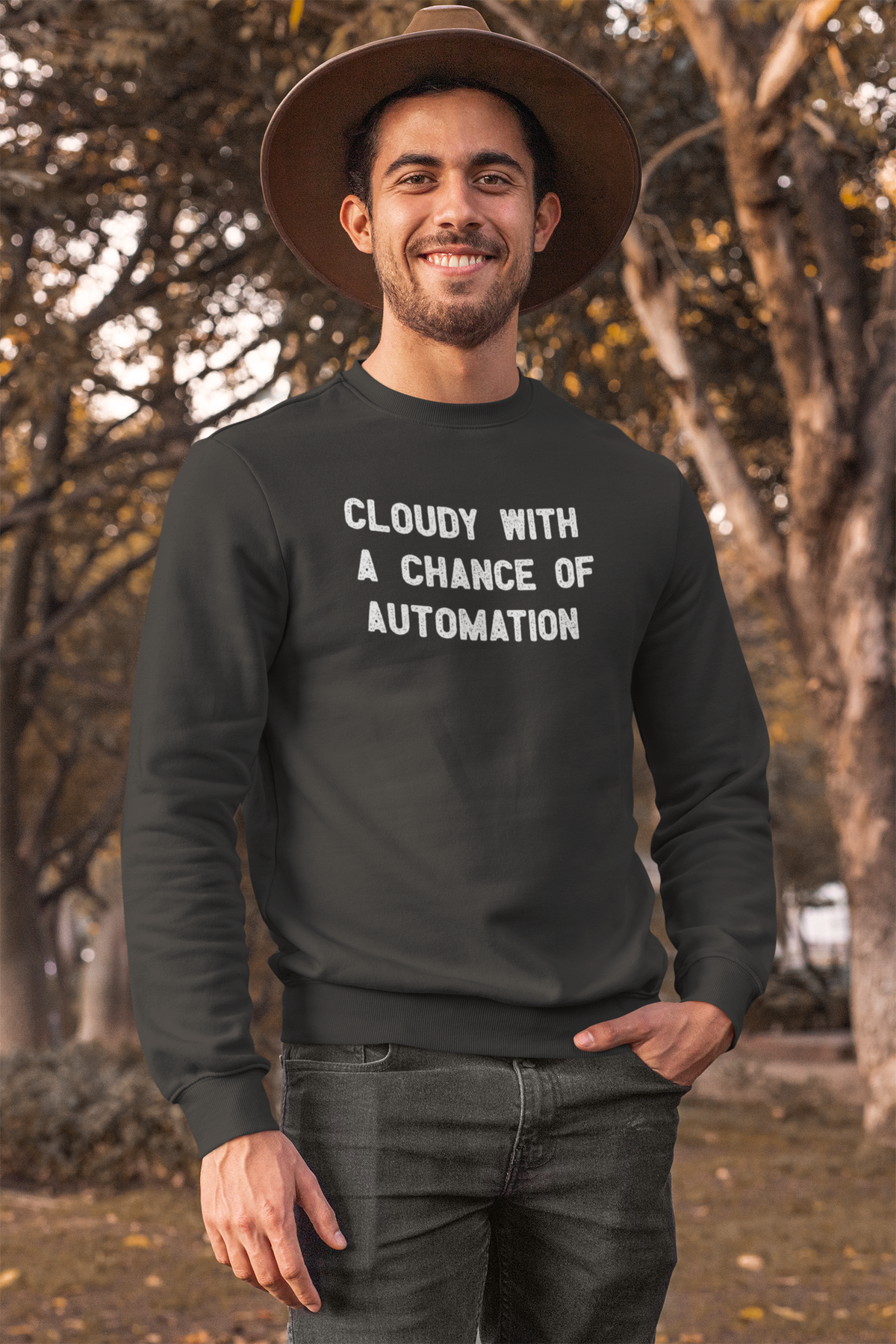 'Cloudy With a Chance of Automation' sweatshirt in black, man wearing it outdoors in a hat, funny DevOps gift