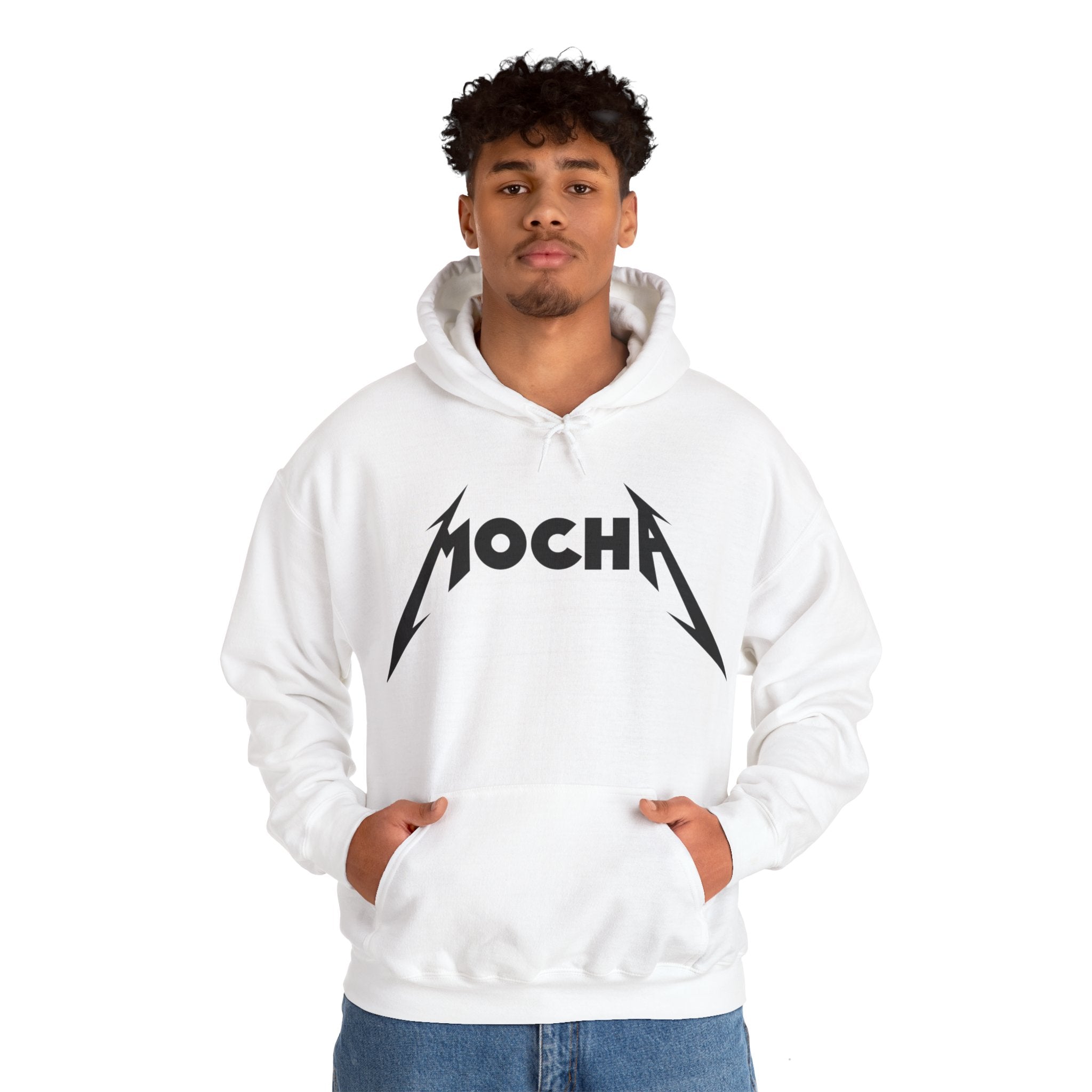 A person is wearing a white Mocha - Hooded Sweatshirt with "MOCHA" printed on the front in a stylized font. They are standing with their hands in the front pocket of the hoodie, showcasing its unique and tasteful blend of style and comfort.