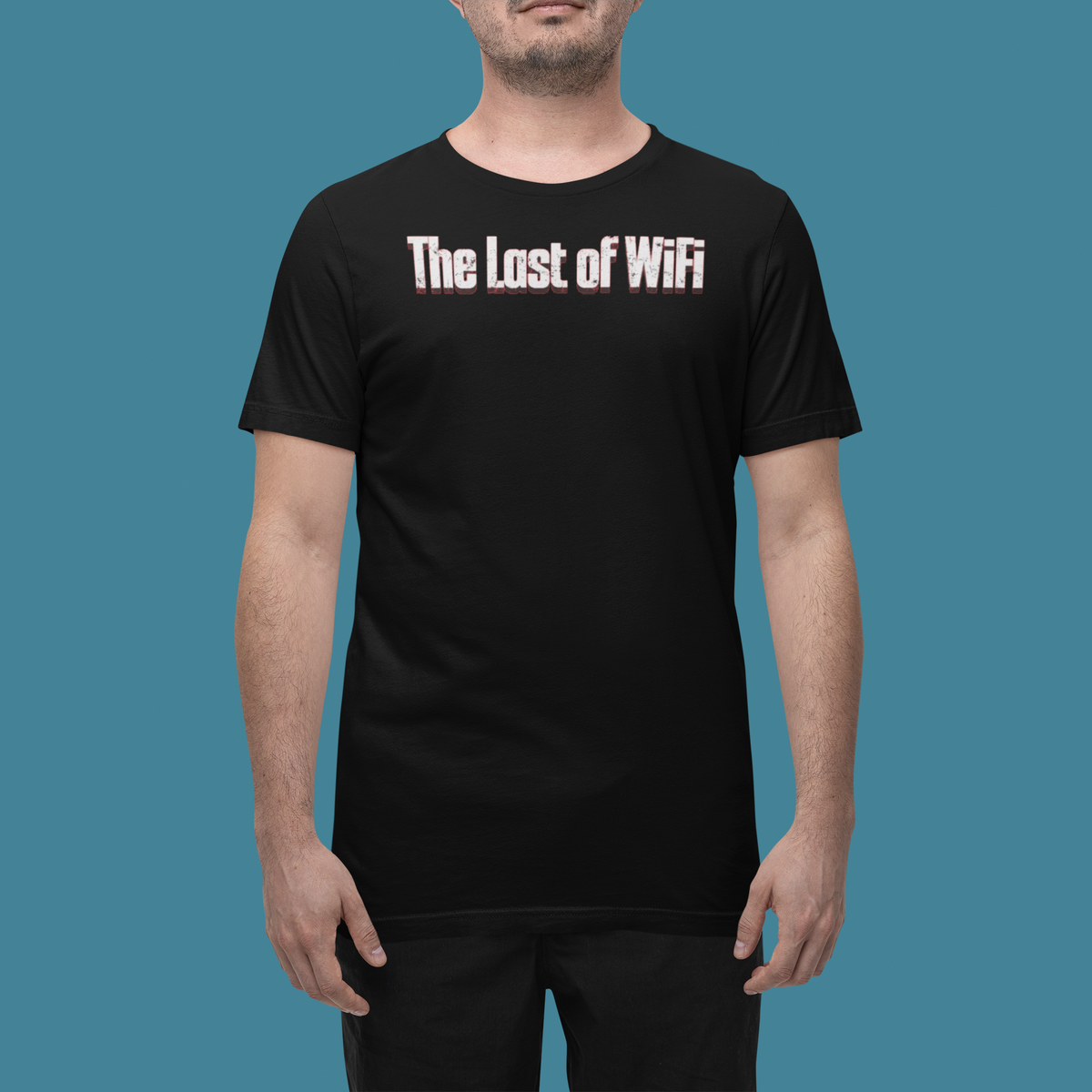 'The Last of Wi-Fi' t-shirt in black, man wearing it in a studio, T-Shirt mockup, Geekpsters