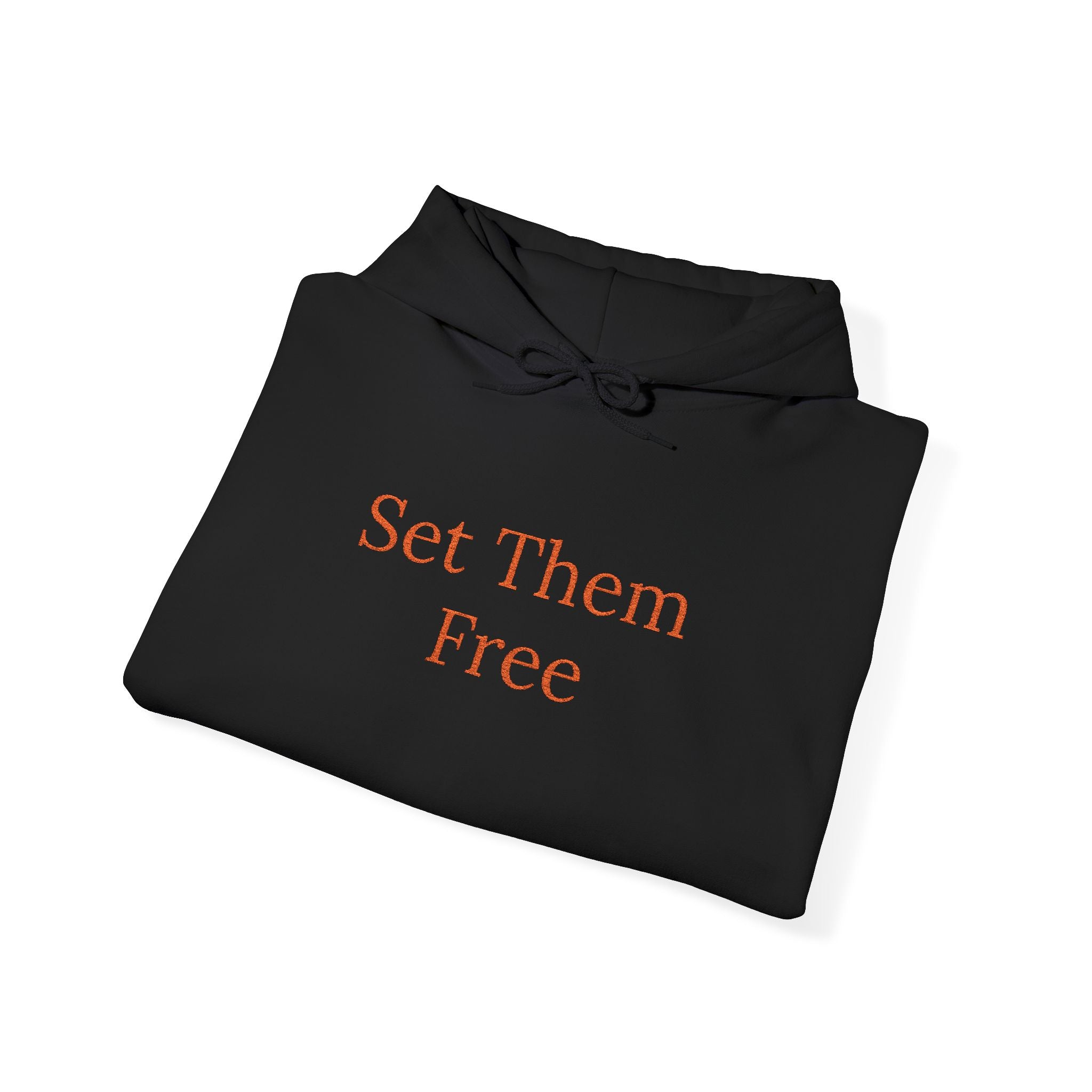 A folded Set Them Free Hoodie — Claude / OpenClaw Moltbot AI Graphic Hoodie, black with bold orange "Set Them Free" text on the front.