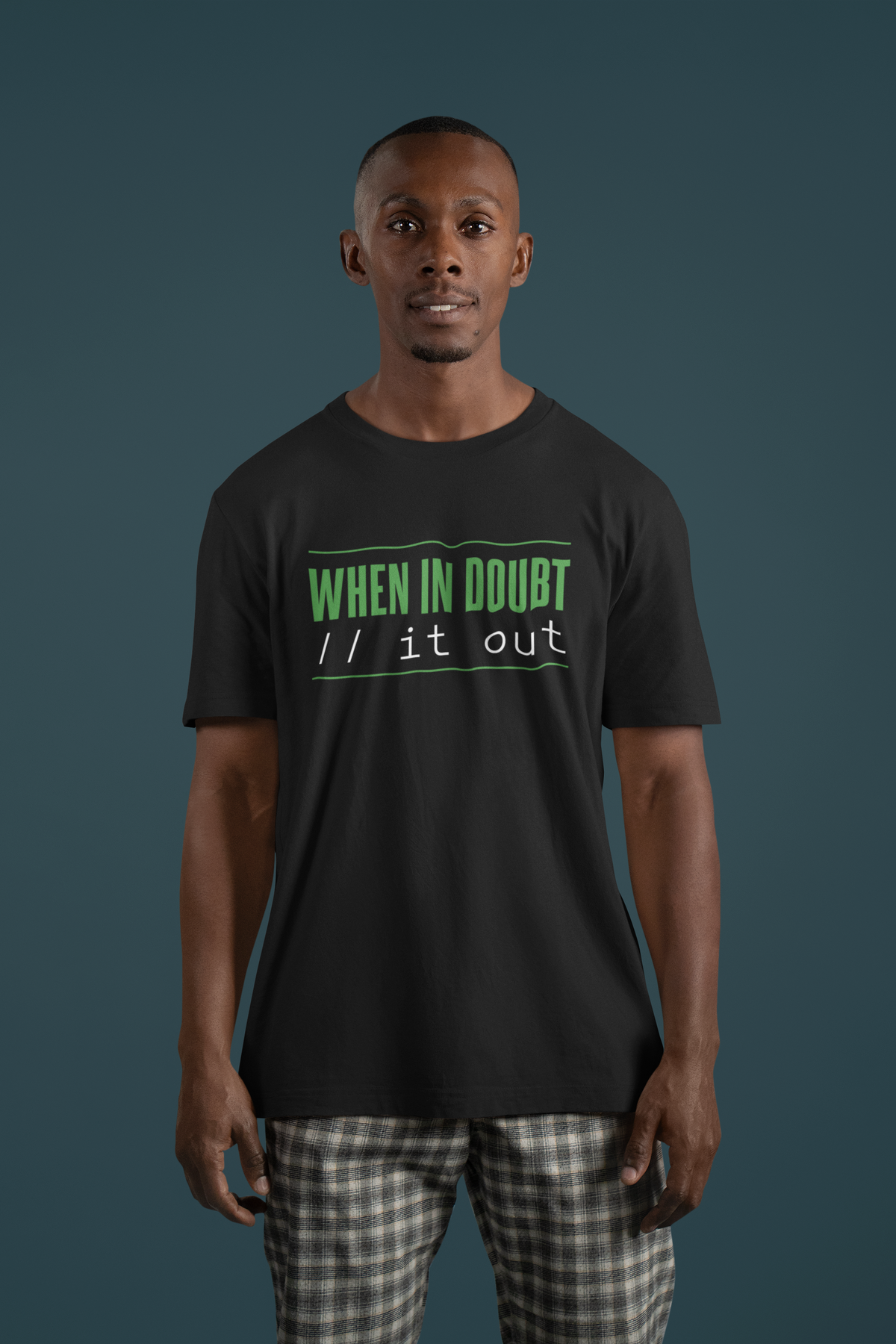 'When In Doubt, Print It Out' t-shirt in black, man model wearing it against a dark teal wall, funny developer gift