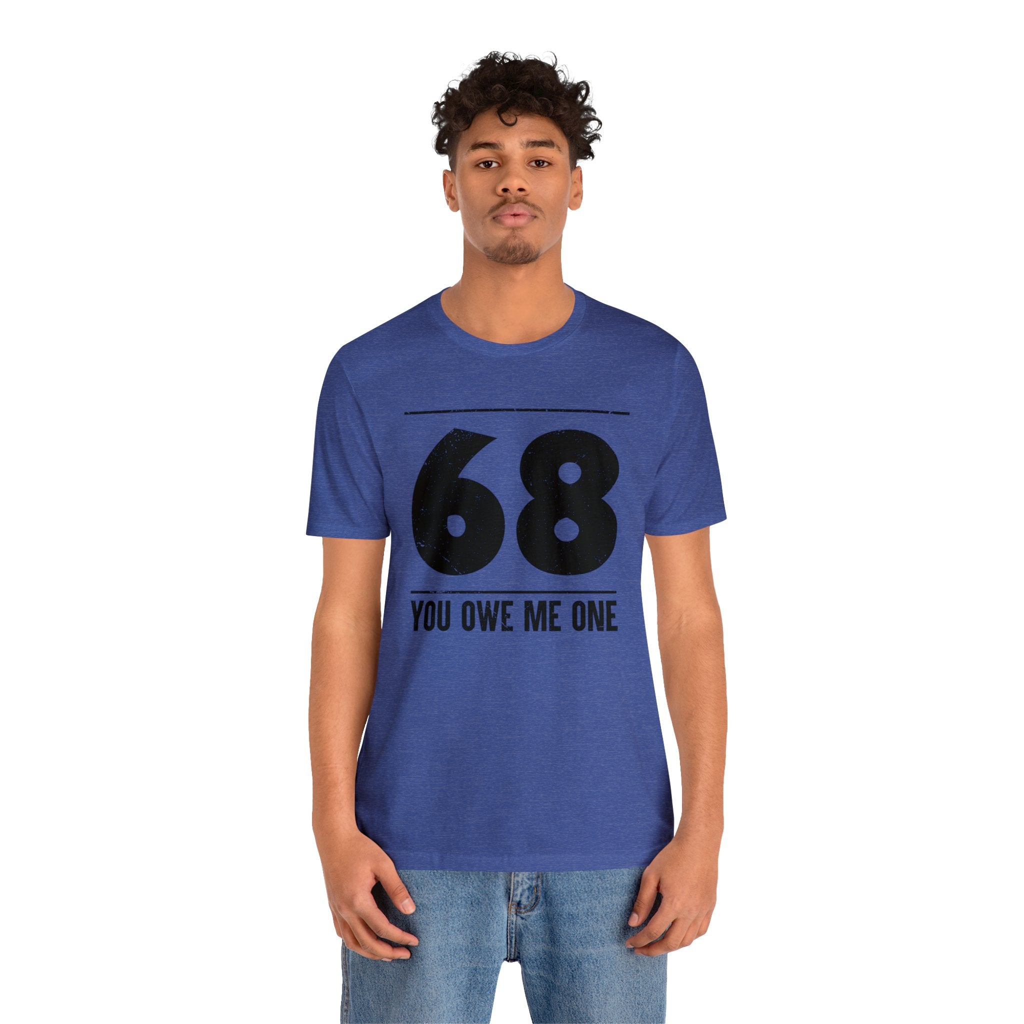 A man wearing a geeky t-shirt that says "68 You Owe Me One.