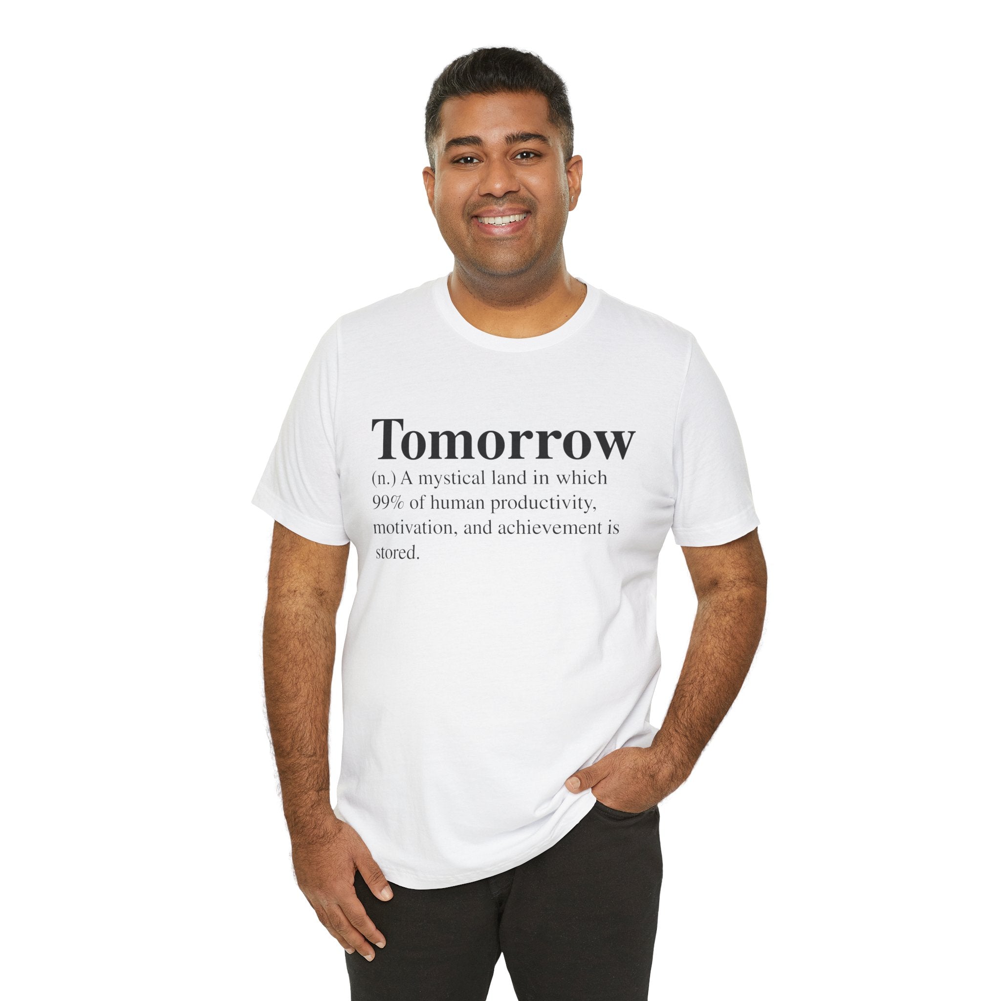 A smiling man in a white unisex 'Tomorrow' T-Shirt with a humorous definition printed on it, standing against a white background.