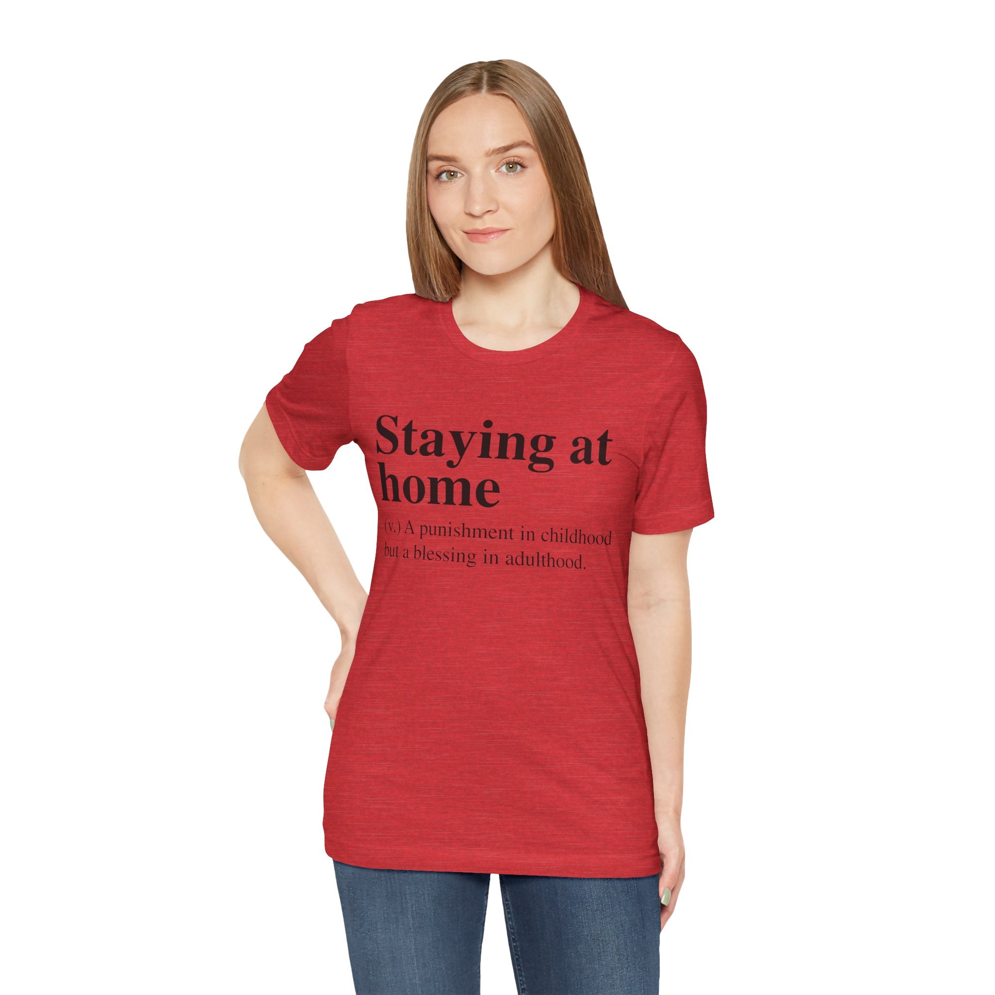 Woman wearing a comfortable fit red Staying at Home T-Shirt with the text "staying at home: a punishment in childhood but a blessing in adulthood" printed on it.