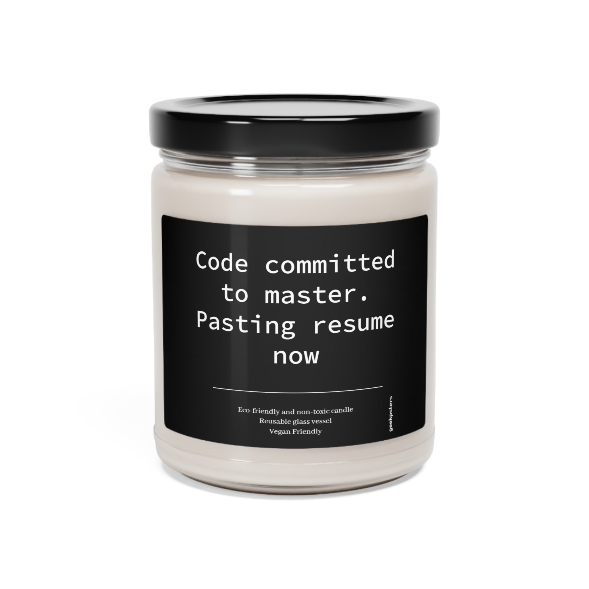 A Code Committed to Master. Pasting Resume Now scented soy candle with a humorous label that says "code committed to master. pasting resume now" indicating a programmer's joke about making a risky code commit.