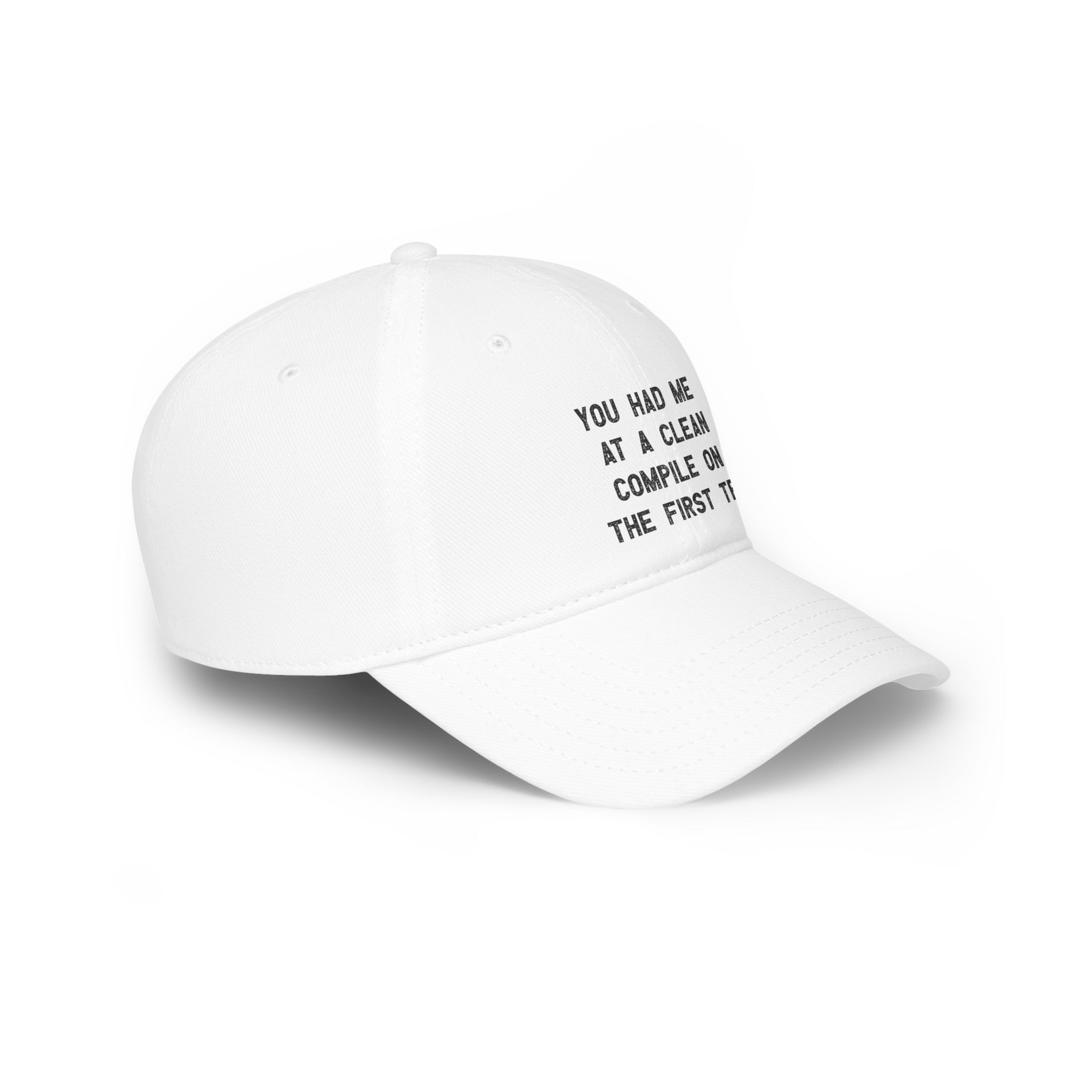 A white You Had Me At a Clean Compile on the First Try - Hat with black text reading "You had me at a clean compile on the first try" embroidered on the front, featuring reinforced stitching for durability. Perfect for those who appreciate coder lingo and a flawless execution.