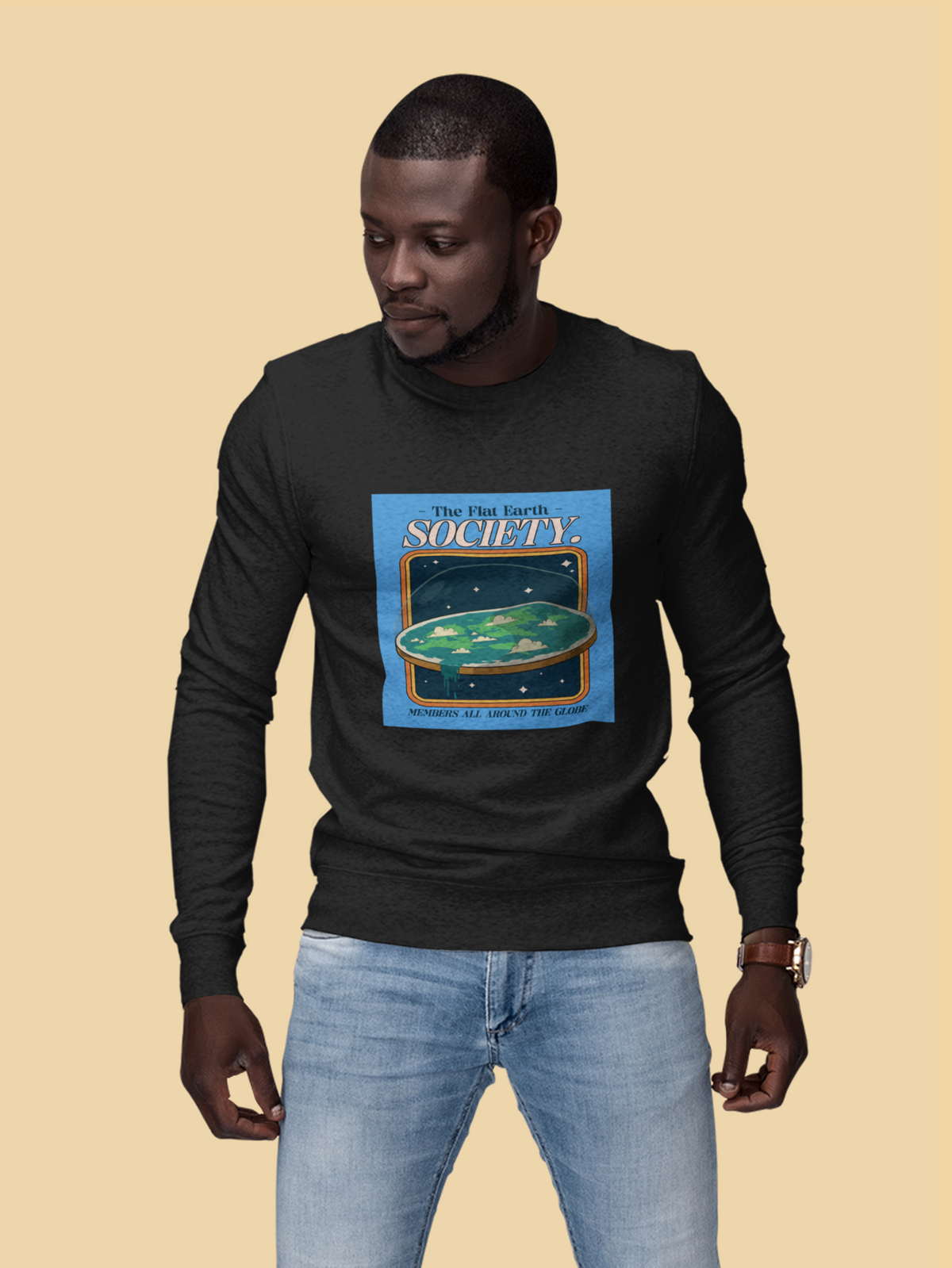 'The Flat Earth Society' sweatshirt in white, man wearing it on mustard backdrop, funny satire gift
