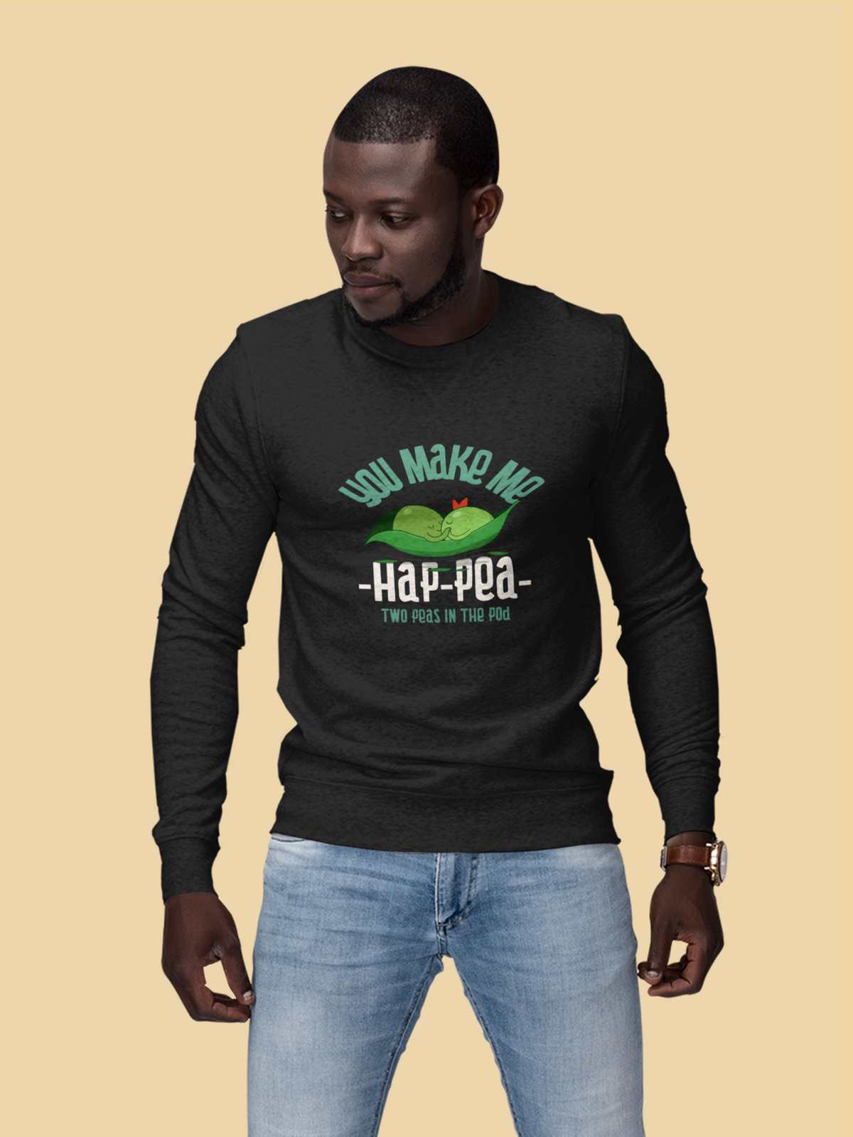 'You Make Me Ha-Pea' pea pun sweatshirt in black, man wearing it, mustard backdrop, veggie pun gift