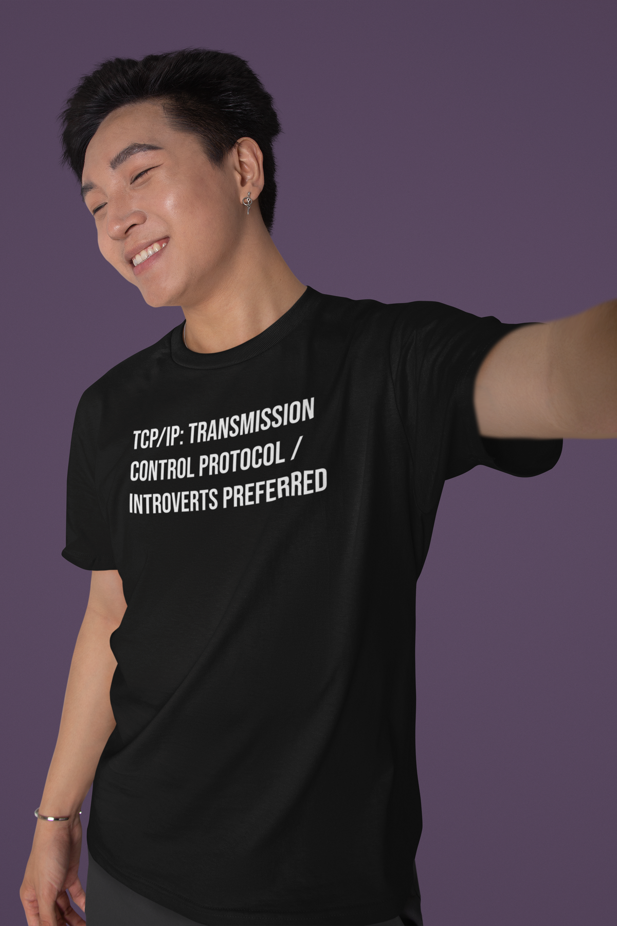'TCP/IP Transmission Control Protocol Introverts Preferred' tee in black, smiling man posing on purple, funny IT gift