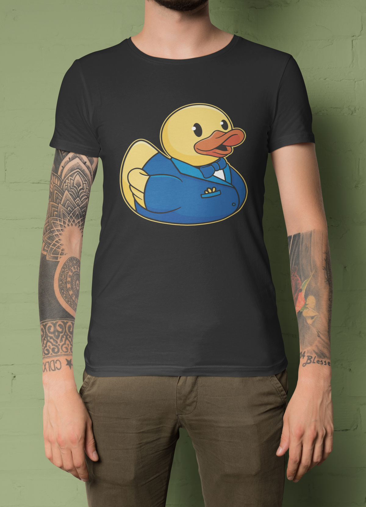 Groom duck t-shirt in dark heather gray, tattooed man model wearing it against a green background, groom gift