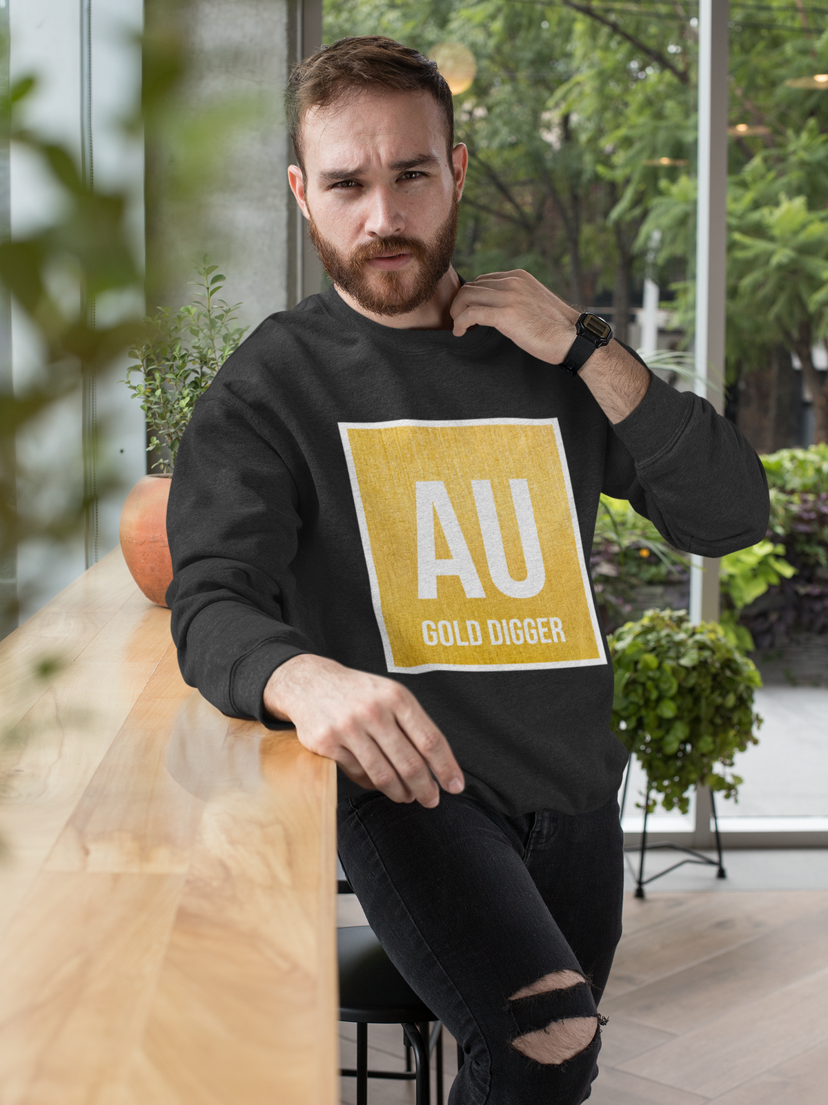 AU Gold Digger crewneck sweatshirt in black, bearded man wearing it outdoors, funny science gift