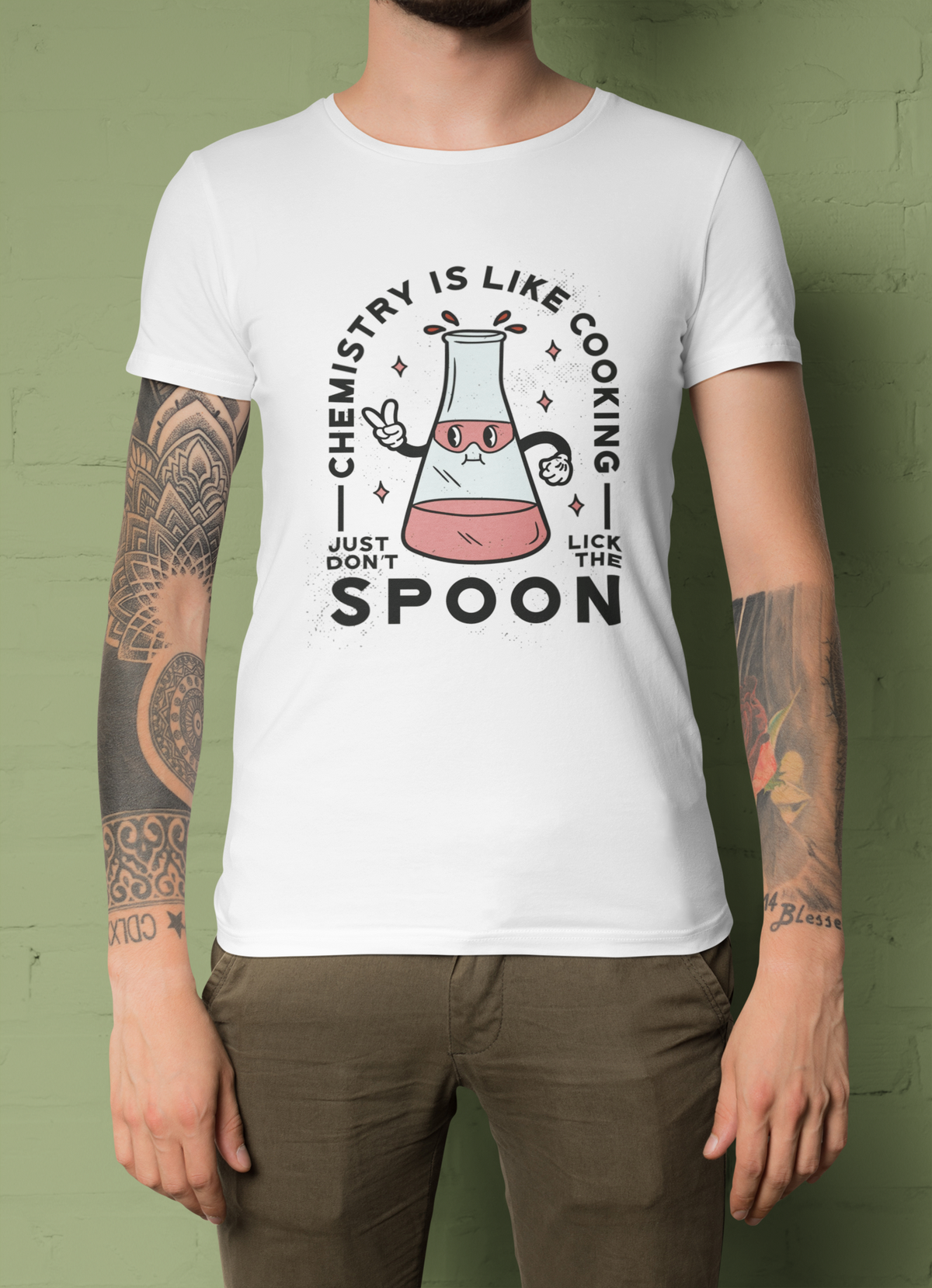'Chemistry Is Like Cooking' t-shirt in white, man model wearing it against an olive green background, science teacher gift