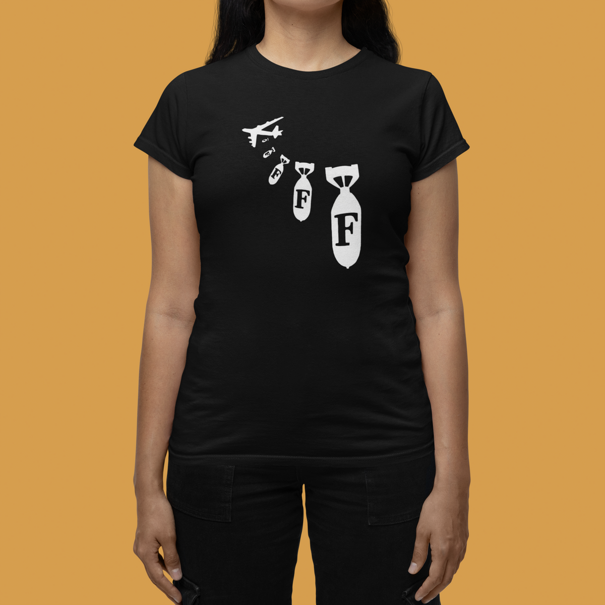 "F Bomb" women's tee in black, woman wearing it on mustard background, funny sarcastic gift tee