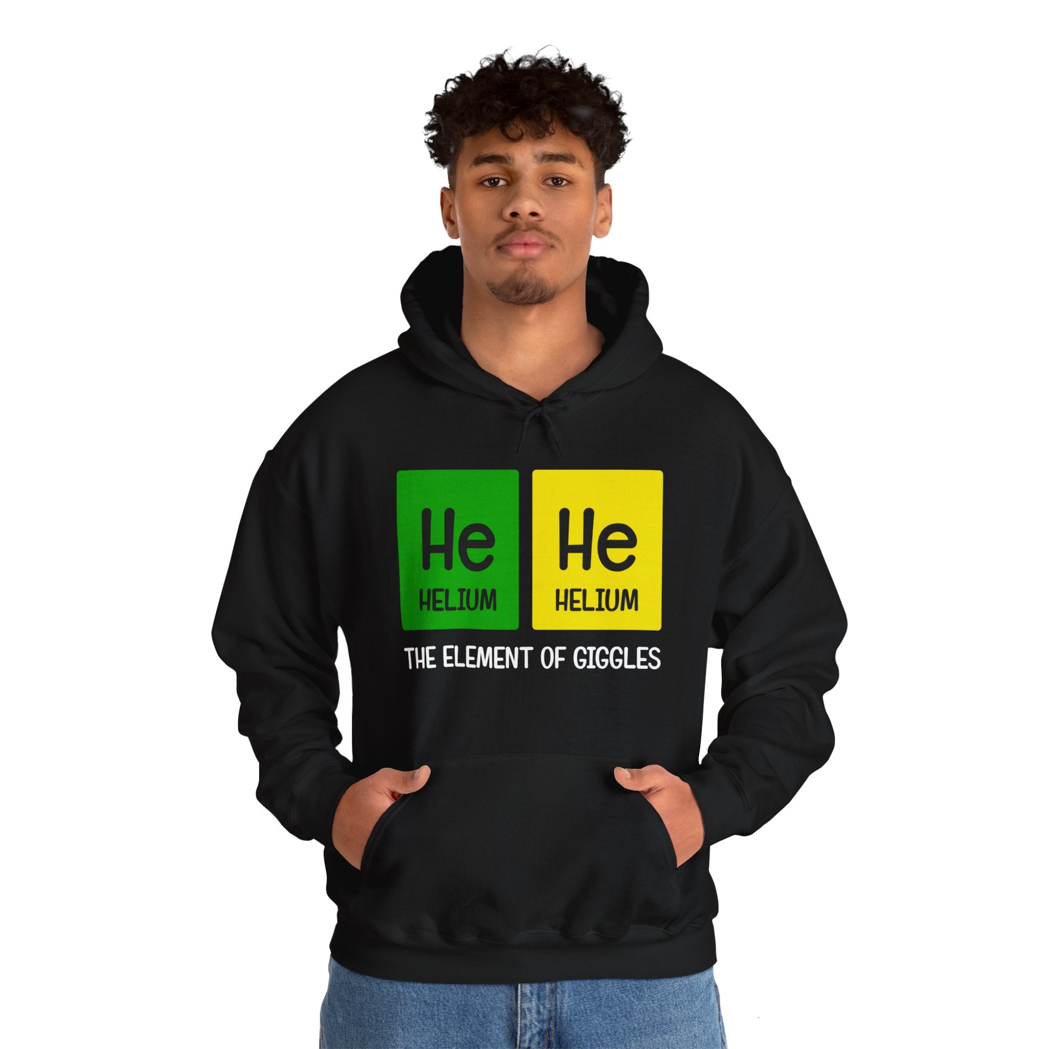 A person wearing a He-He - Hooded Sweatshirt with a periodic table design featuring "He-He designs" and "The Element of Giggles" text.