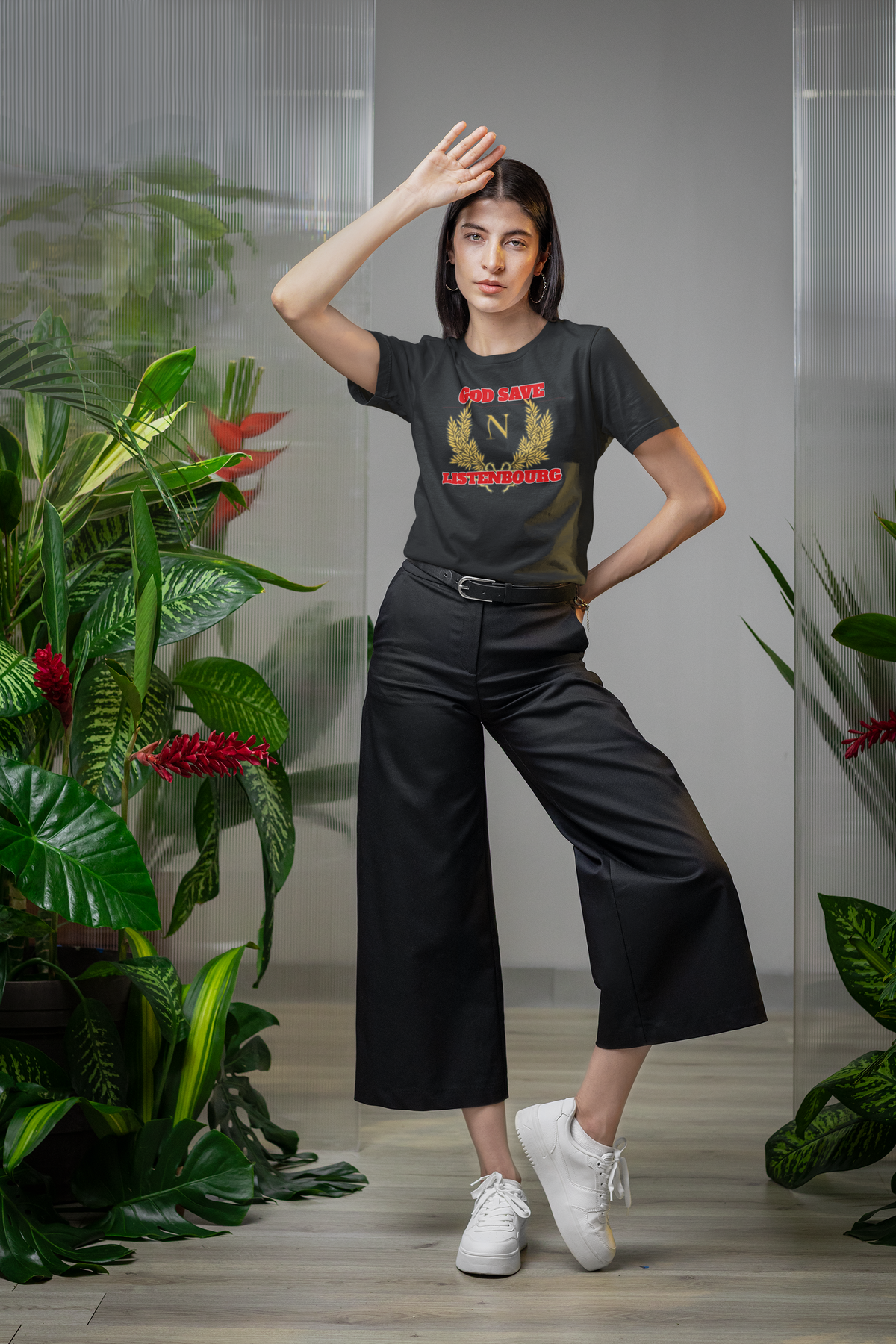 'God Save Listenbourg' t-shirt in black, woman modeling it with plants