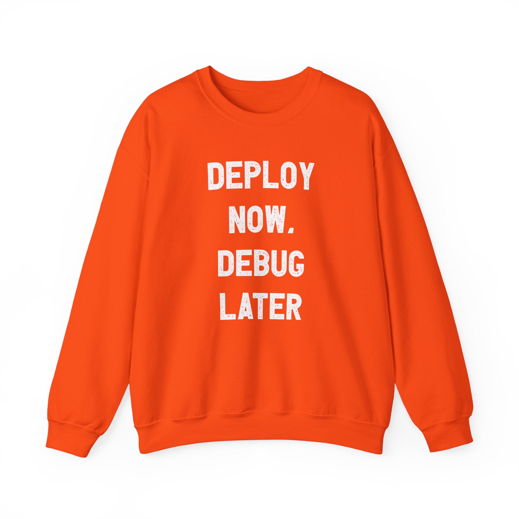 Ideal for tech enthusiasts facing chilly weather, the Deploy Now, Debug Later sweatshirt comes in a vibrant orange with striking white text proclaiming "DEPLOY NOW, DEBUG LATER.