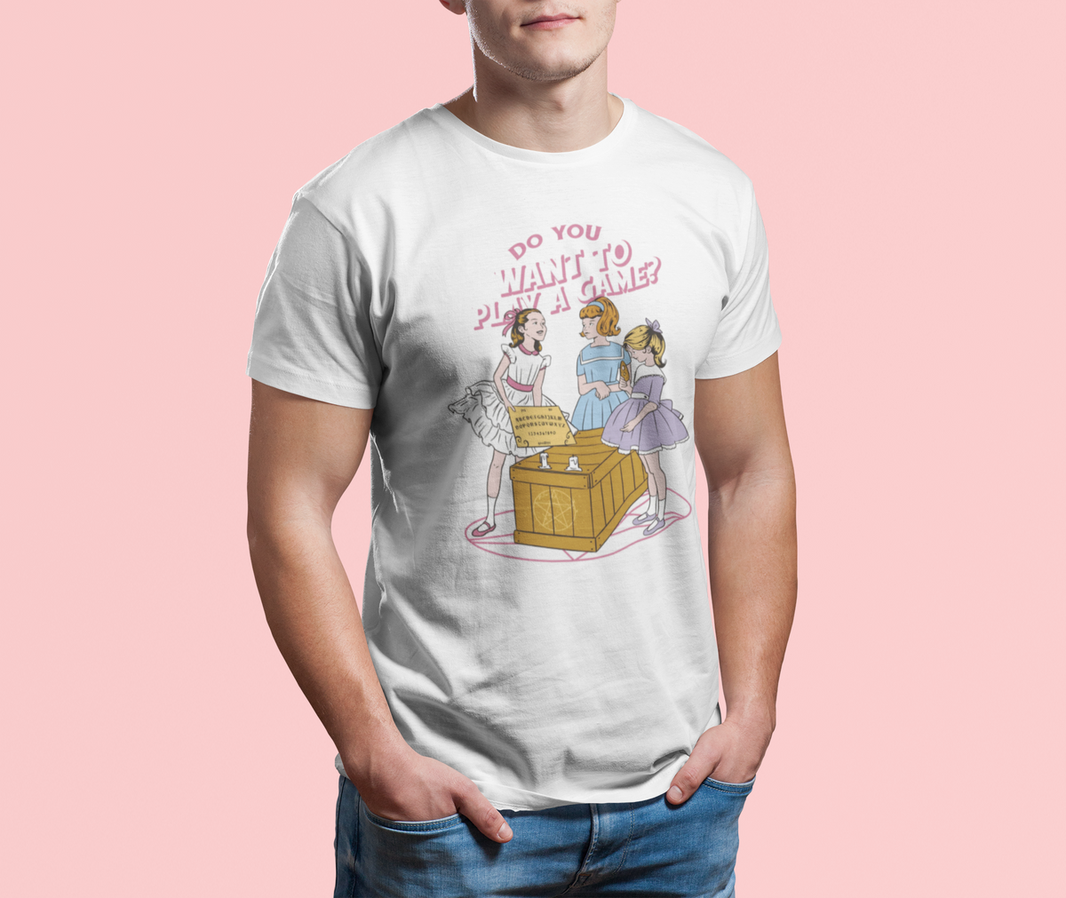 'Do You Want to Play a Game' t-shirt in white, man model wearing it against a pink background, funny horror movie gift
