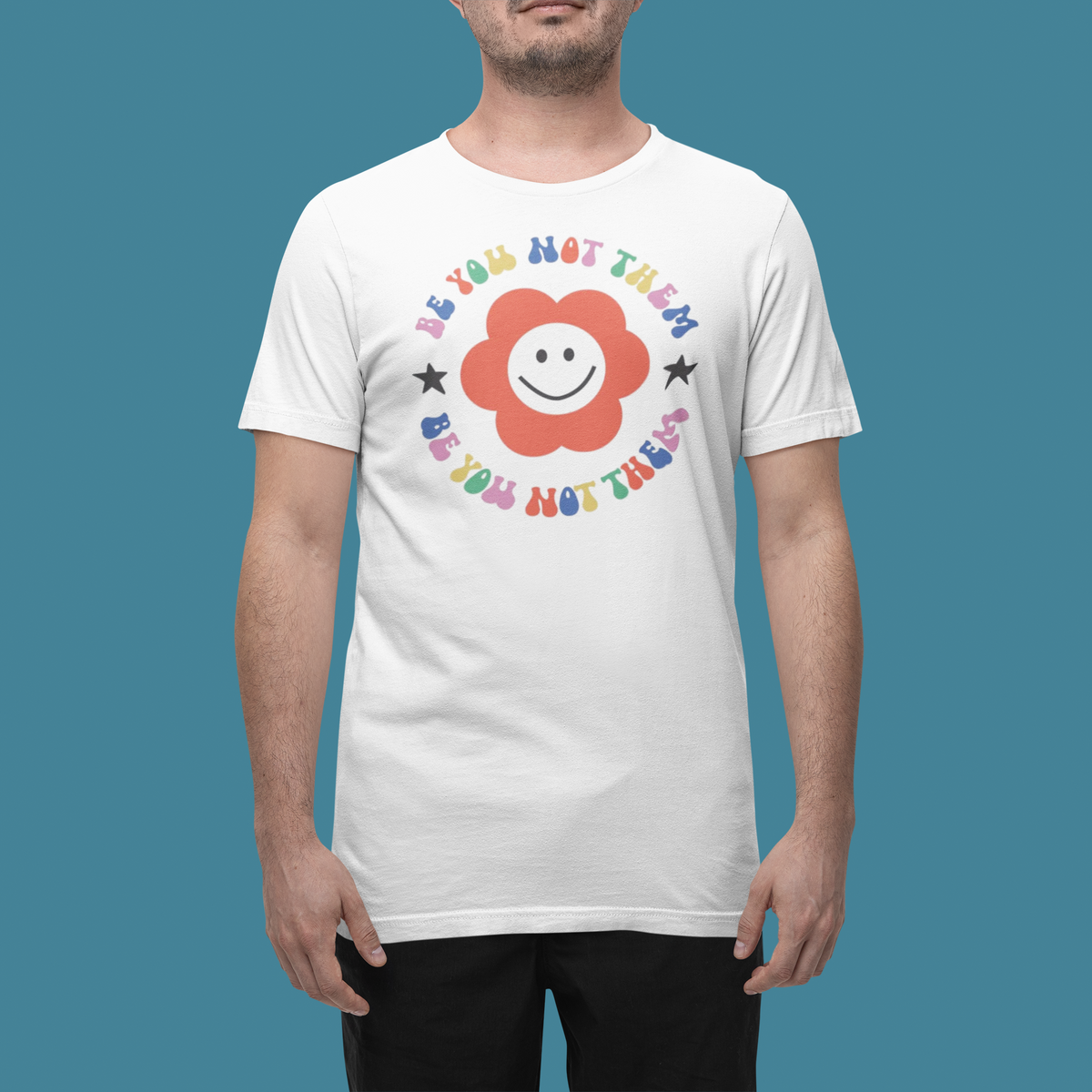 'Be You Not Them' t-shirt in white, man wearing it in a studio, T-Shirt mockup, Geekpsters
