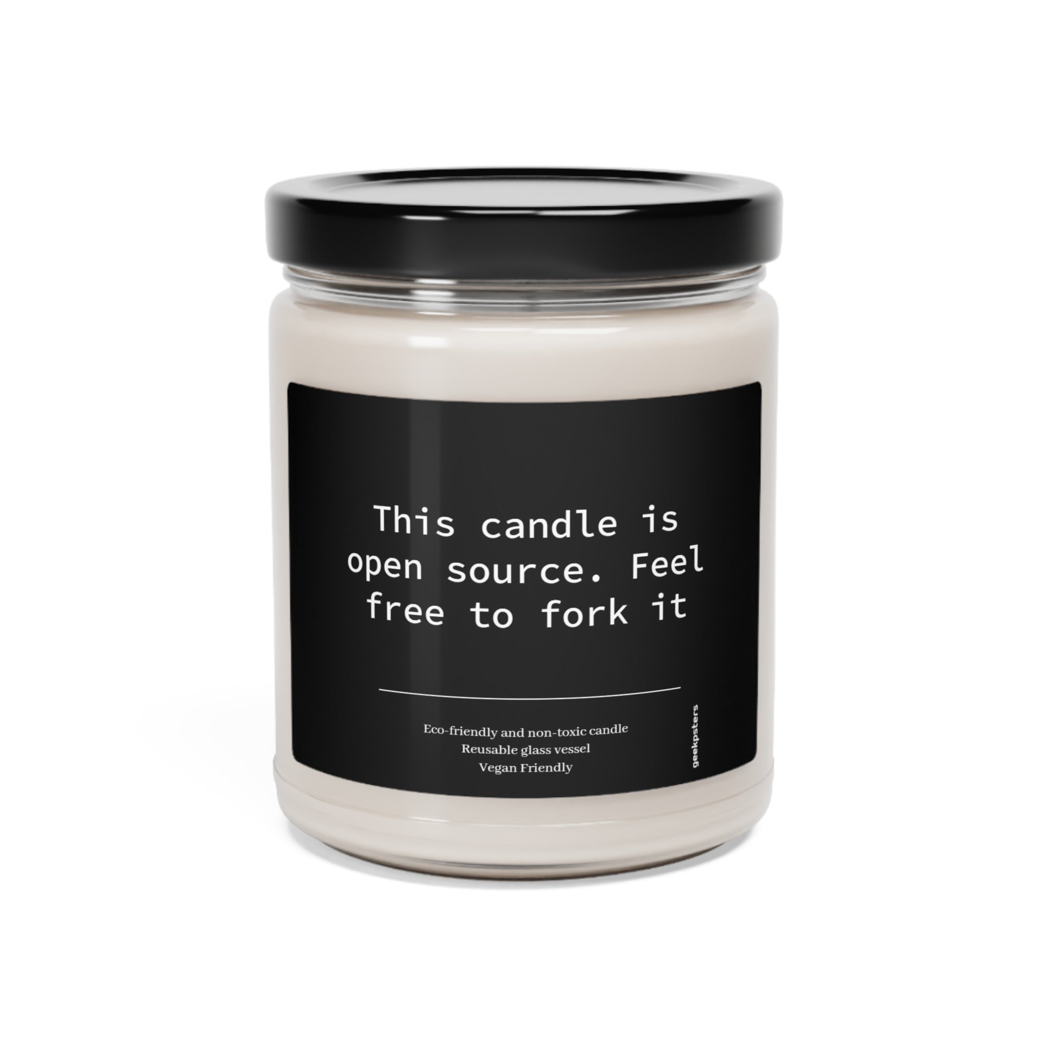 A scented Soy candle in a glass jar with a label that reads "this candle is open source. feel free to fork it" indicating it's environmentally friendly and vegan.