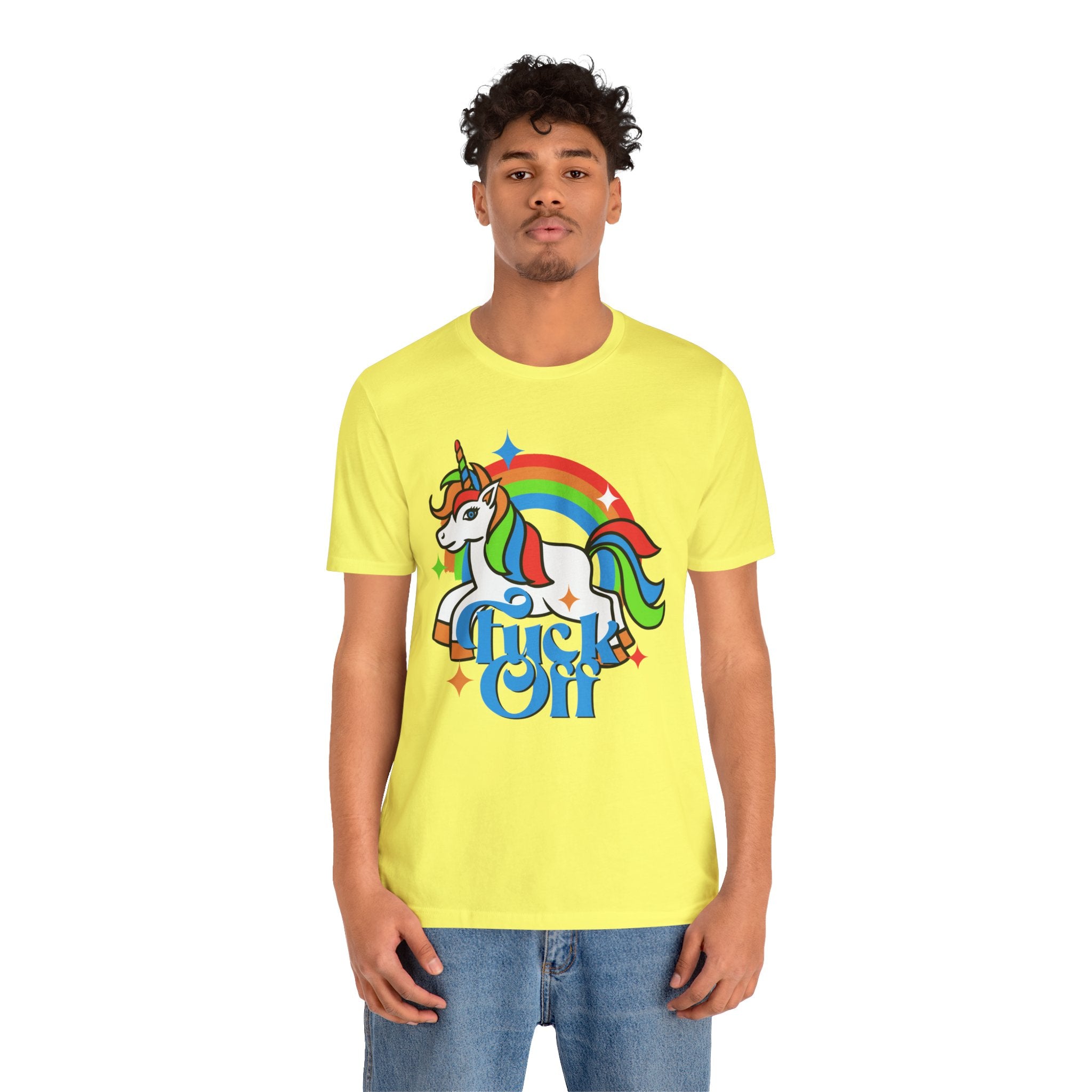 Young man wearing a bright yellow unisex F off T-Shirt with a unicorn and rainbow graphic and the phrase "f*ck off" printed in quality print on it.