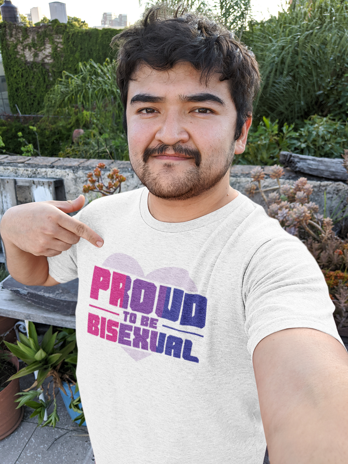 'Proud to Be Bisexual' T-shirt in white, man wearing it outdoors in a garden, bi pride gift shirt