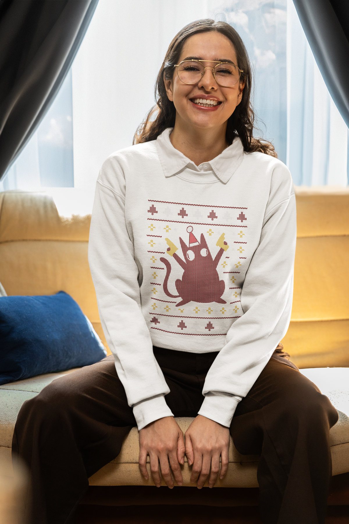 Ugly Sweater Cat sweatshirt in white, woman sitting indoors wearing it, cozy funny cat lover gift