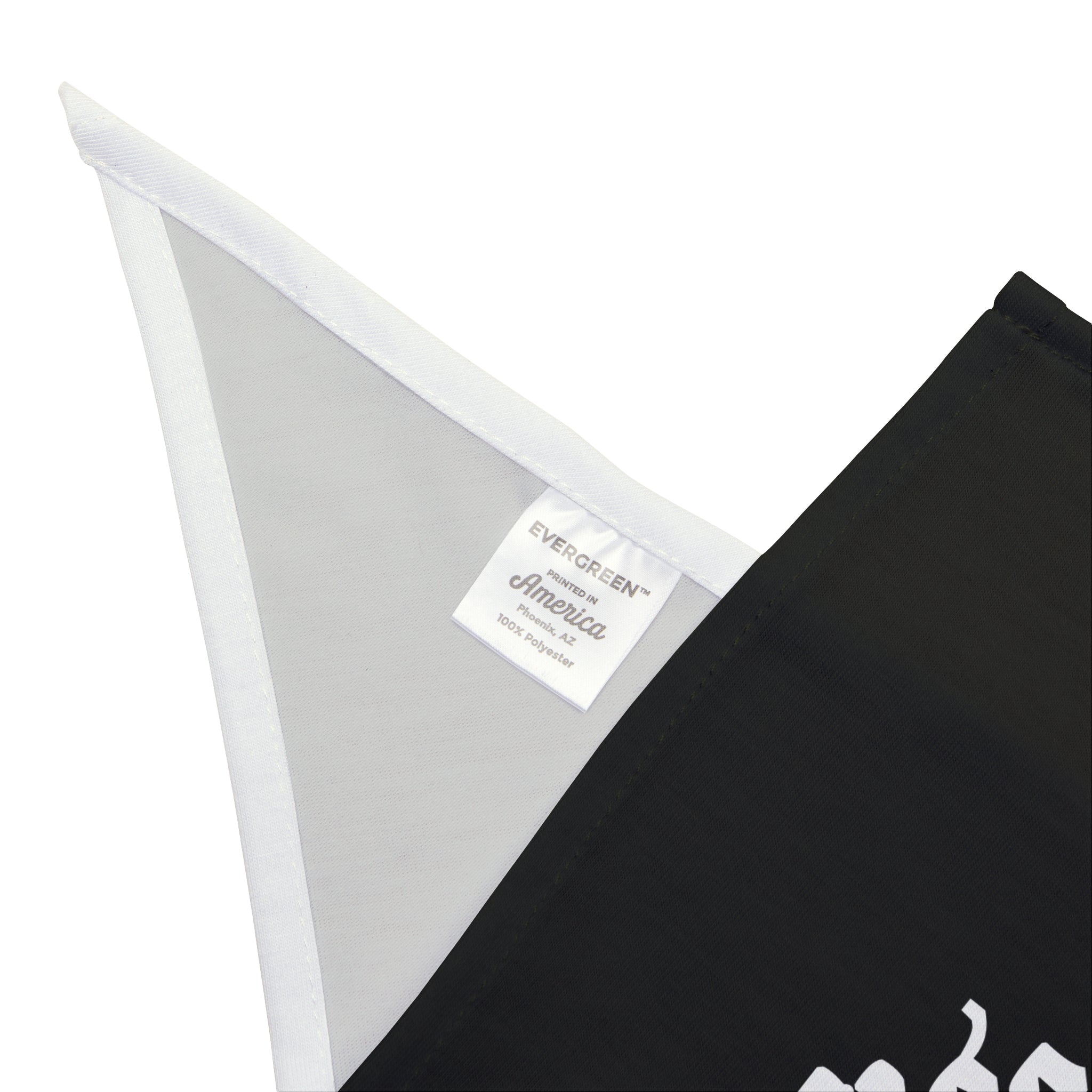 Close-up of the Prophet of the Petabyte Pet Bandana showcasing a white label with the text "Evergreen America 100% polyester" set against a black and white background.