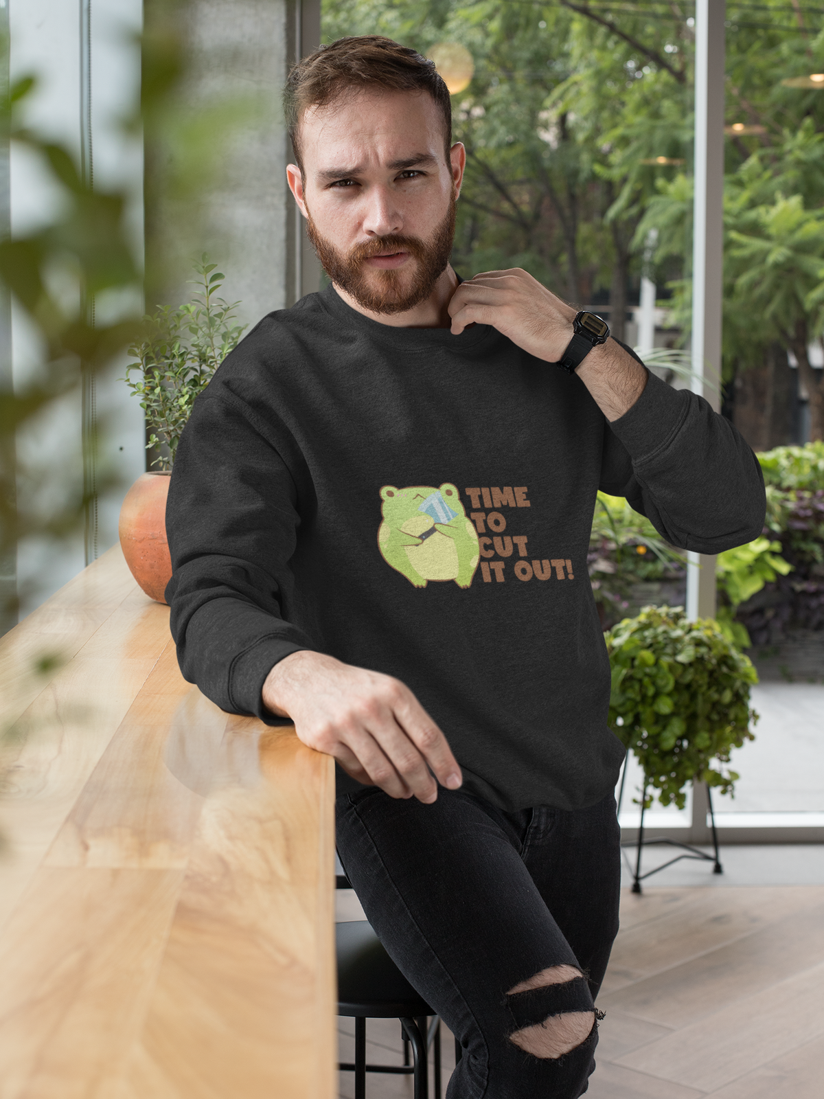'Time to Cut It Out' frog sweatshirt in charcoal, bearded man wearing it indoors, funny pun gift