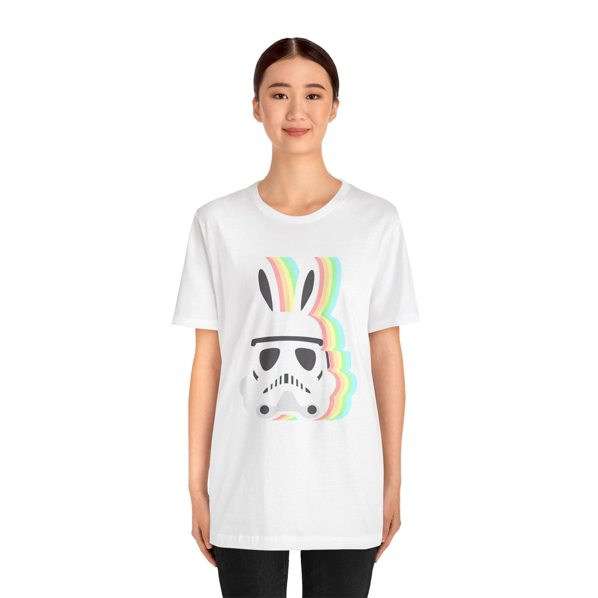 A young woman wearing a white tee featuring a graphic of the Easter Stormtrooper Bunny with colorful stripes.