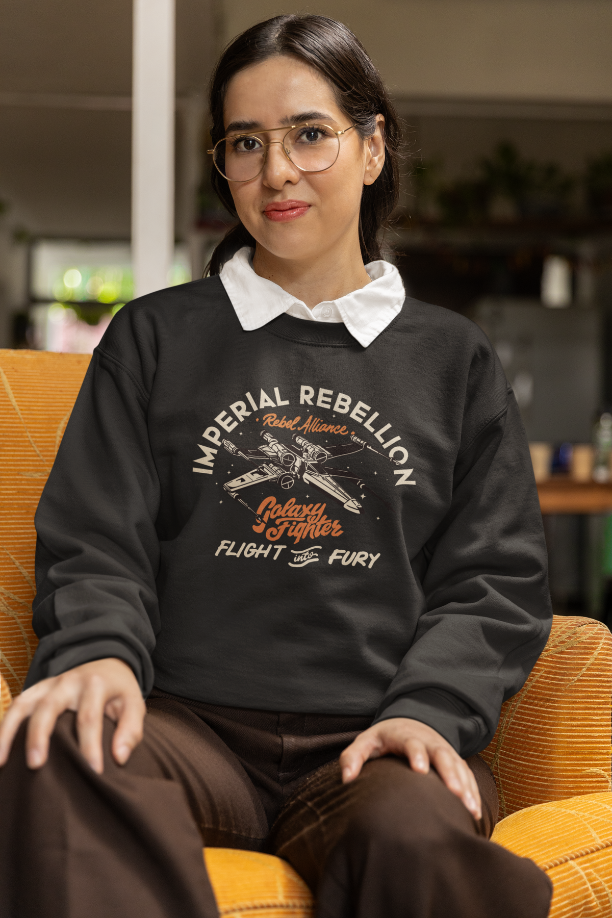 "Imperial Rebellion" fighter jet sweatshirt in black, woman wearing it seated in glasses, sci-fi gift for her