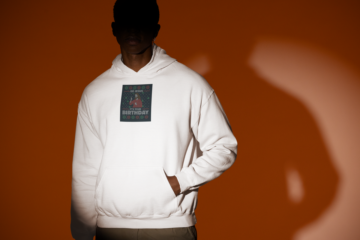 'Go Jesus It's Your Birthday Ugly Sweater Hoodie' in white, man under a spotlight, Hoodie mockup, Geekpsters