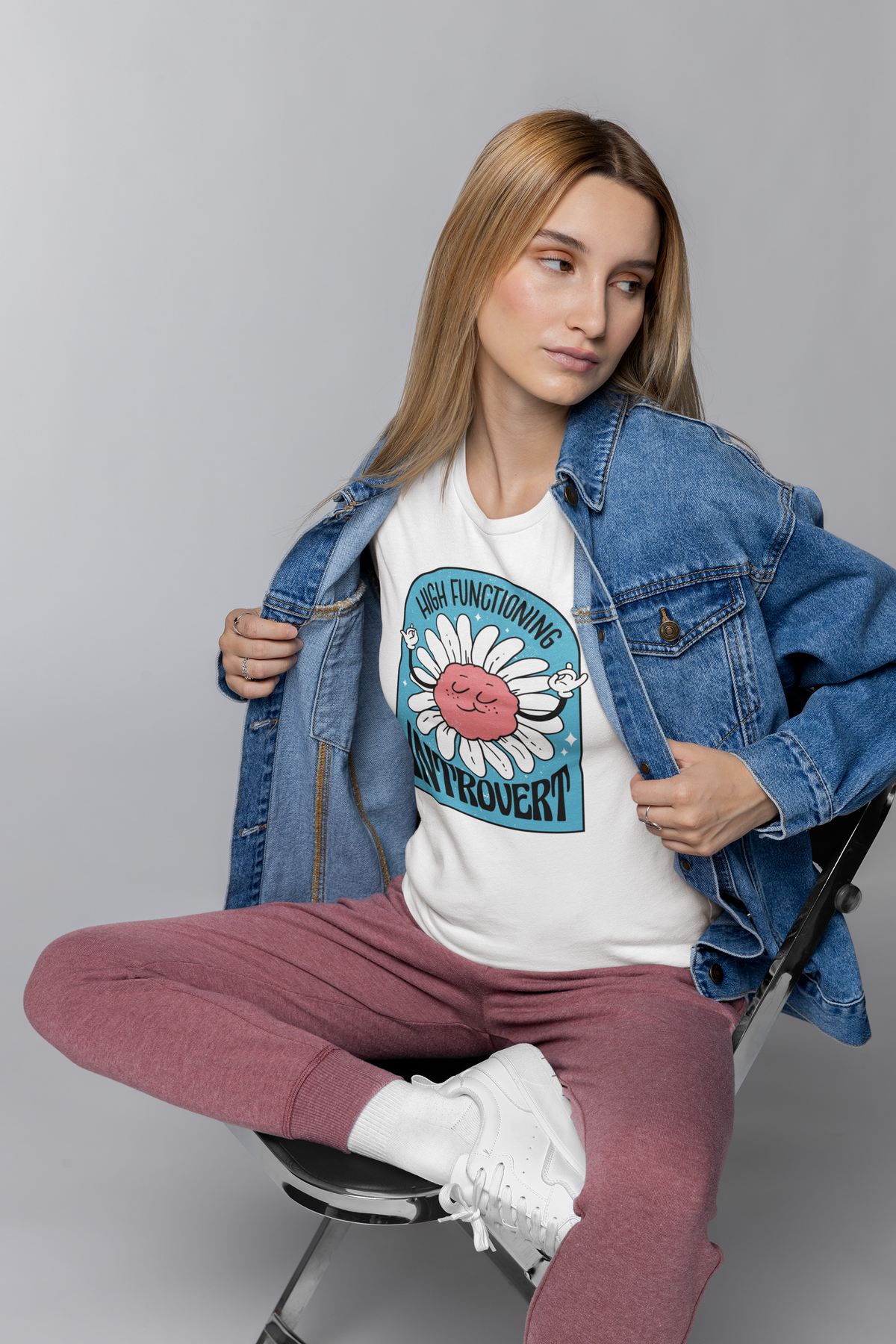 'High Functioning Introvert' t-shirt in white, woman wearing it under an open denim jacket